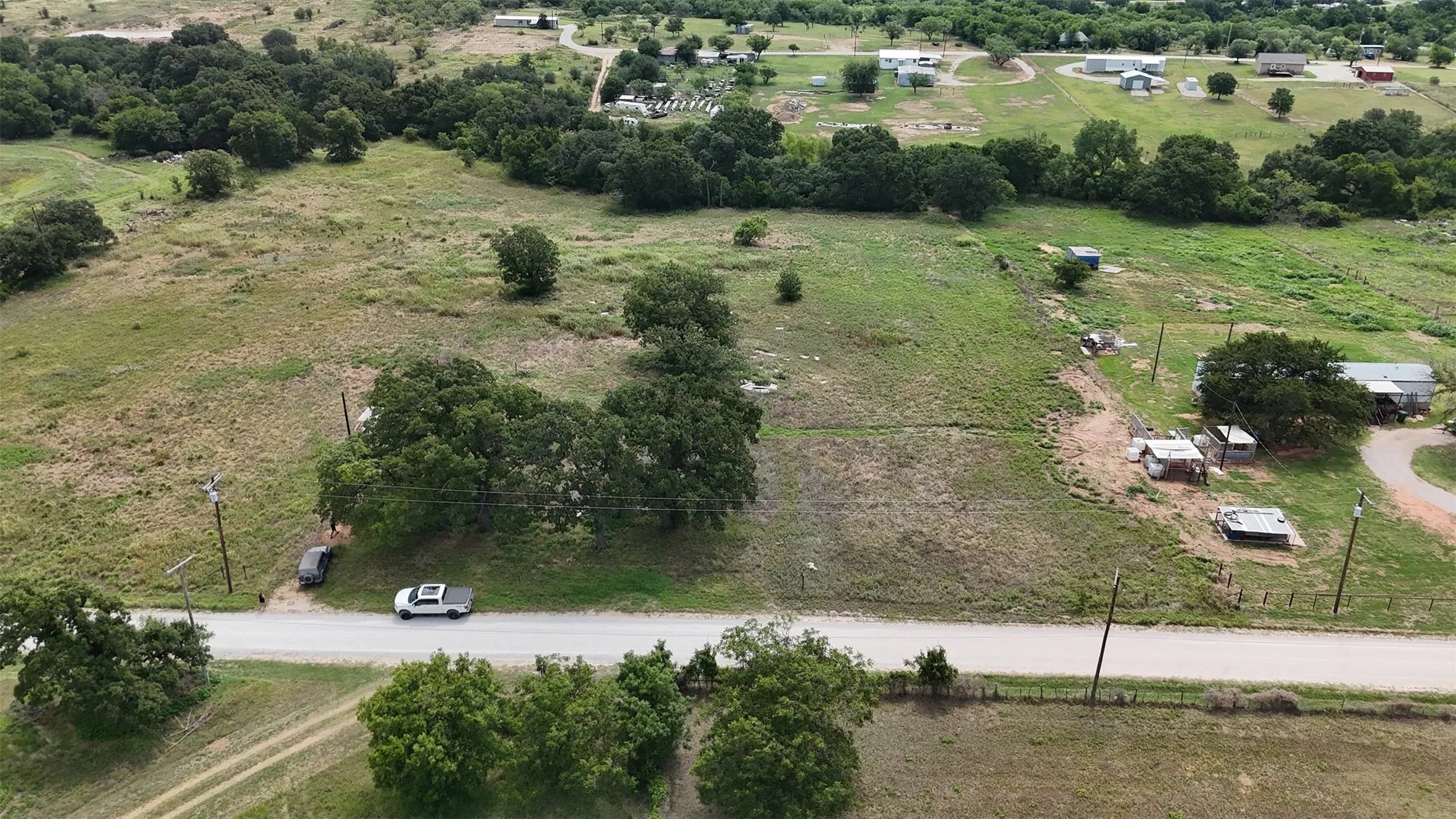 Expansive undeveloped lot featuring mature trees and a flat topography
