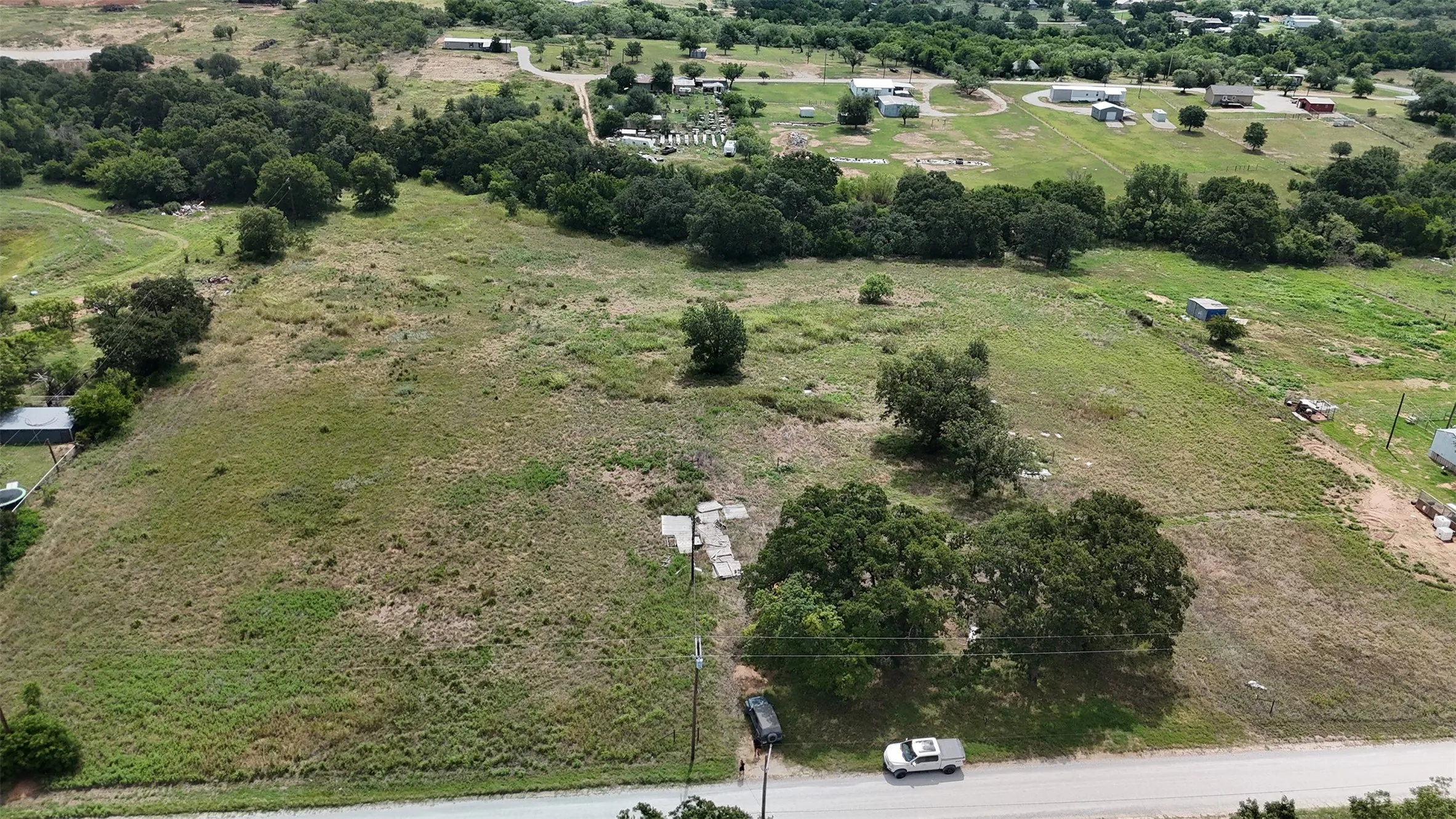 Expansive undeveloped lot featuring varied topography and established trees
