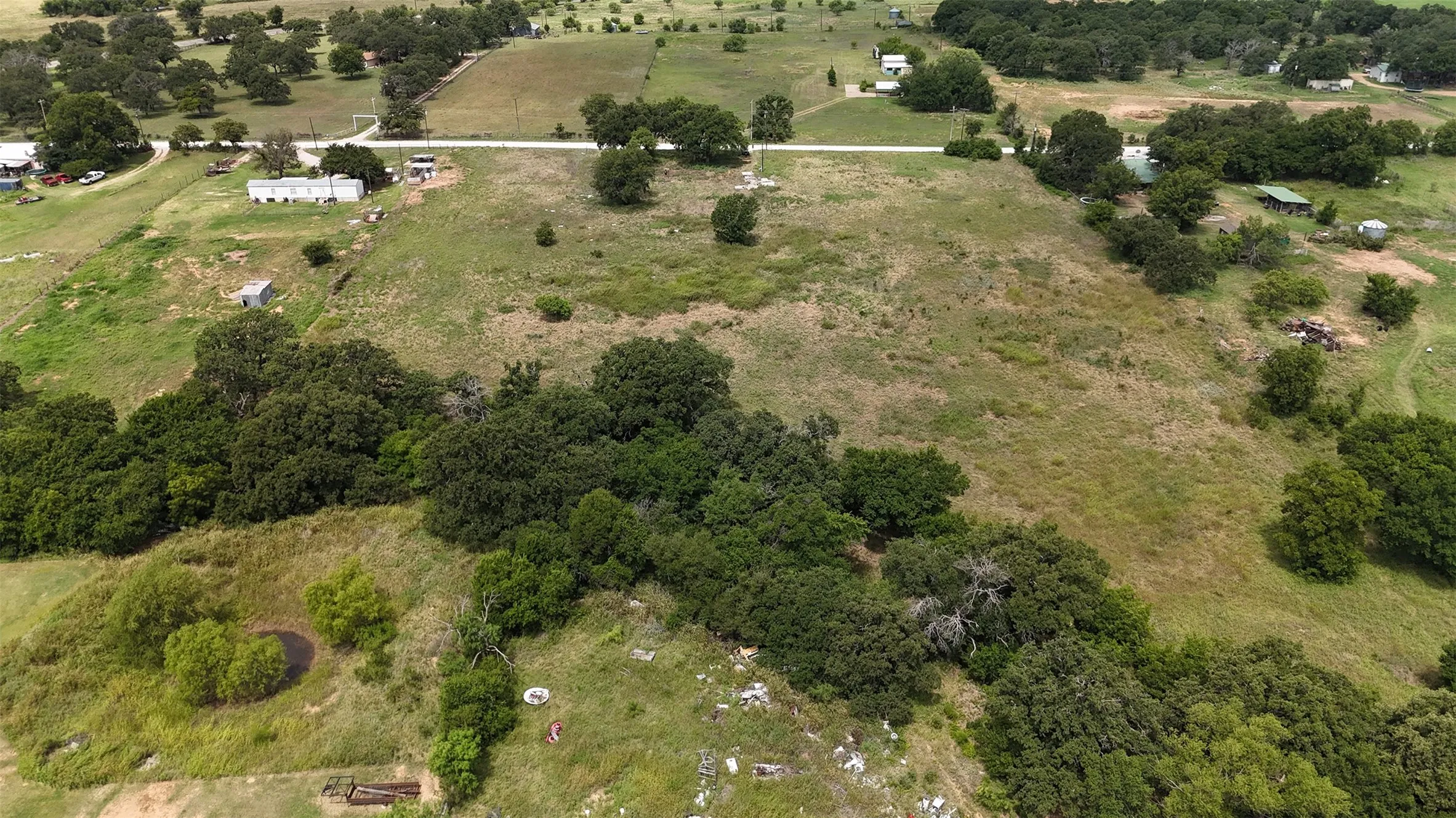 Expansive undeveloped land featuring a mix of open grassy areas and mature trees