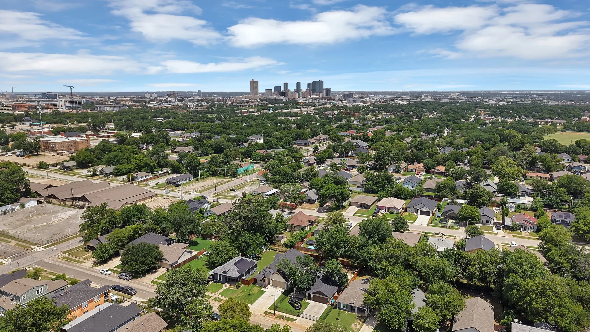 Aerial perspective showcasing an expansive residential area with a verdant tree canopy