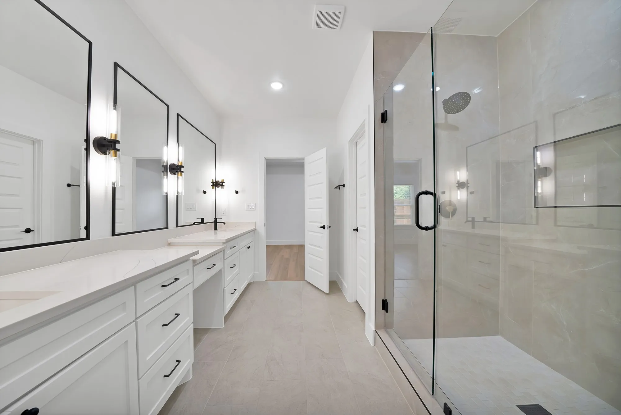 Spacious bathroom featuring a dual vanity with white cabinetry and light-toned countertops