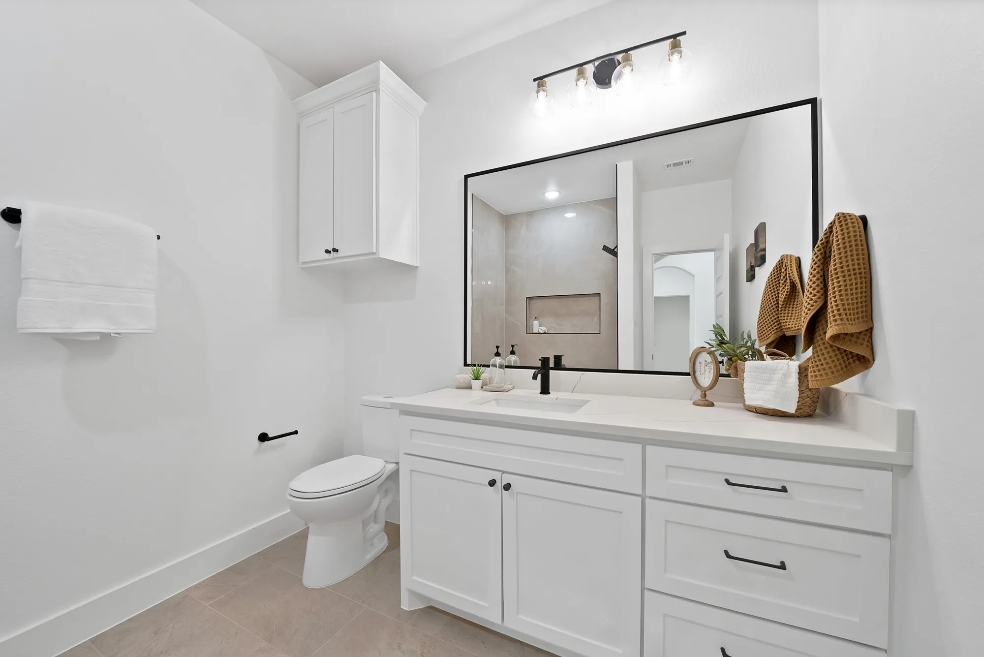 Vanity featuring a white countertop, undermount sink, and matte black faucet