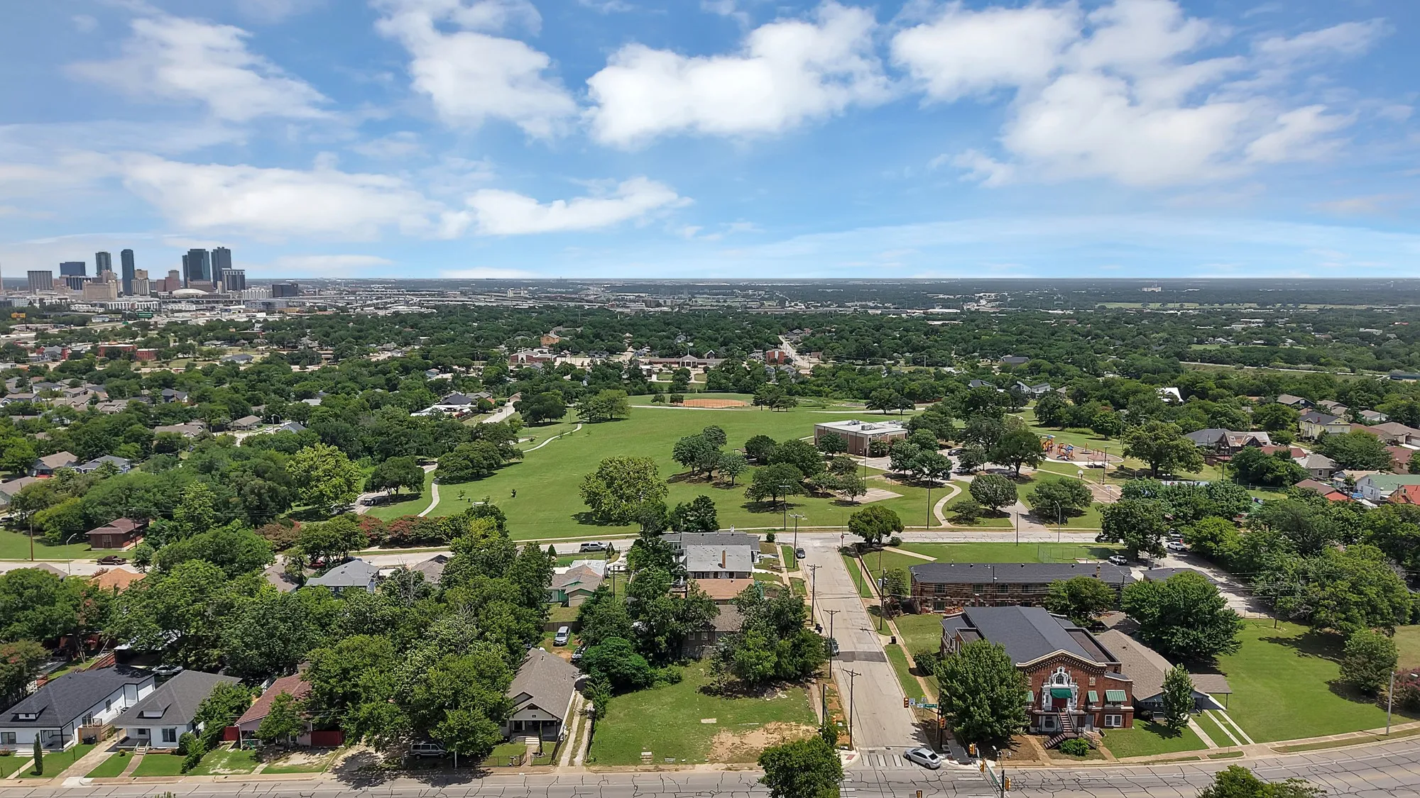 Expansive aerial perspective showcasing a verdant urban landscape with mature tree canopies