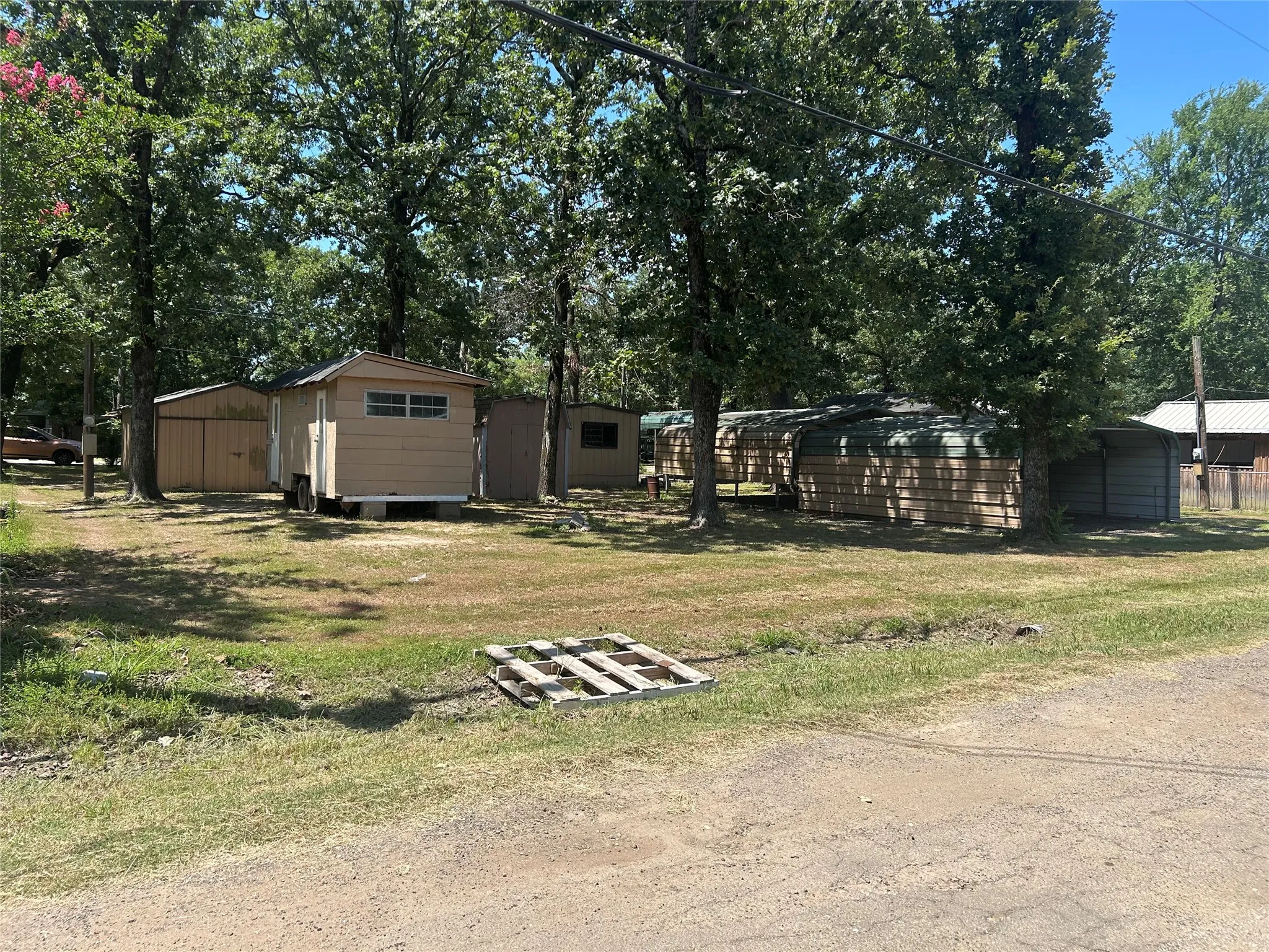Back side of property showing RV and Boat parking and coverings.