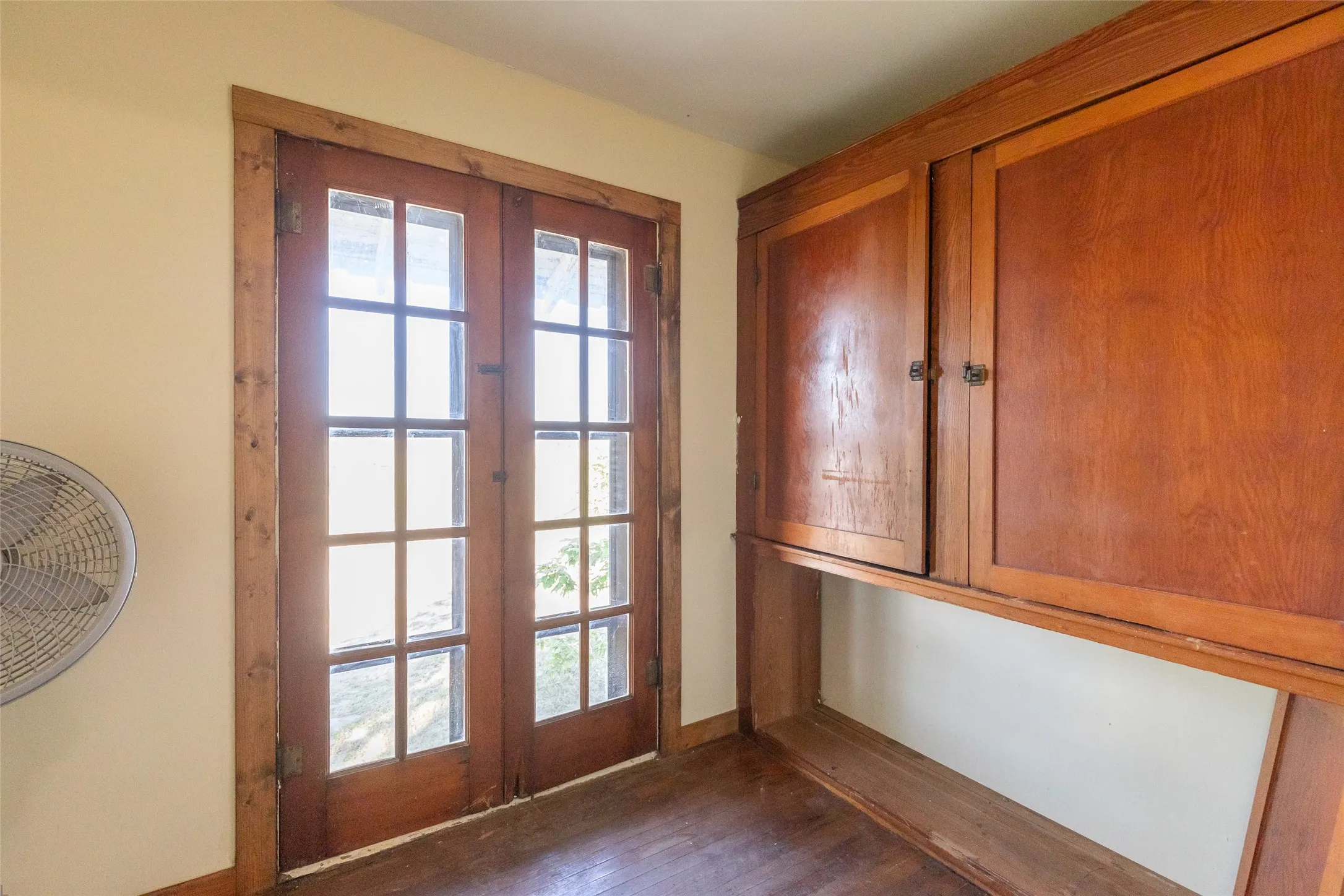 Wood-finish French doors with multiple glass panes