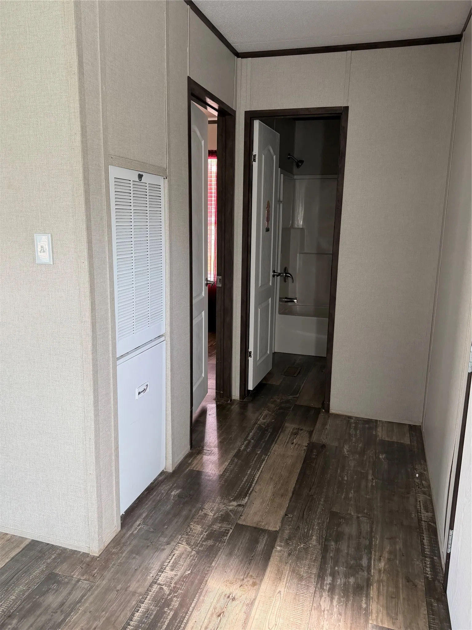 Hallway featuring wide-plank wood-finish flooring