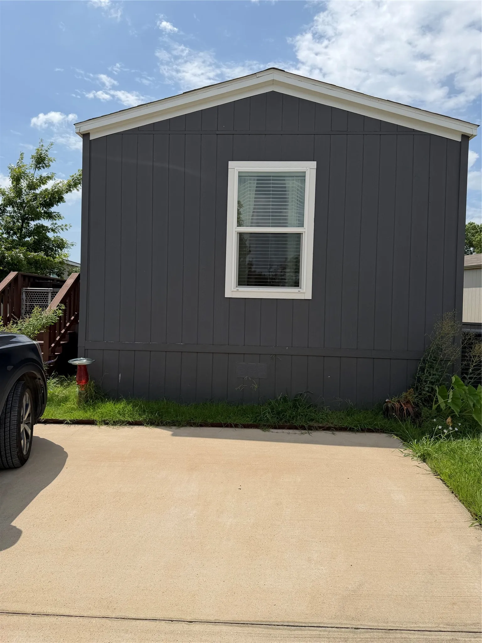 Charcoal gray vertical panel siding with white trim