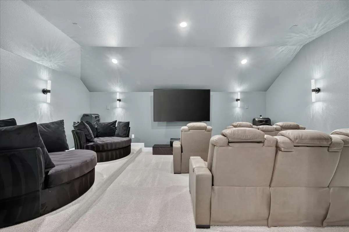 Dedicated theater space featuring a large wall-mounted screen