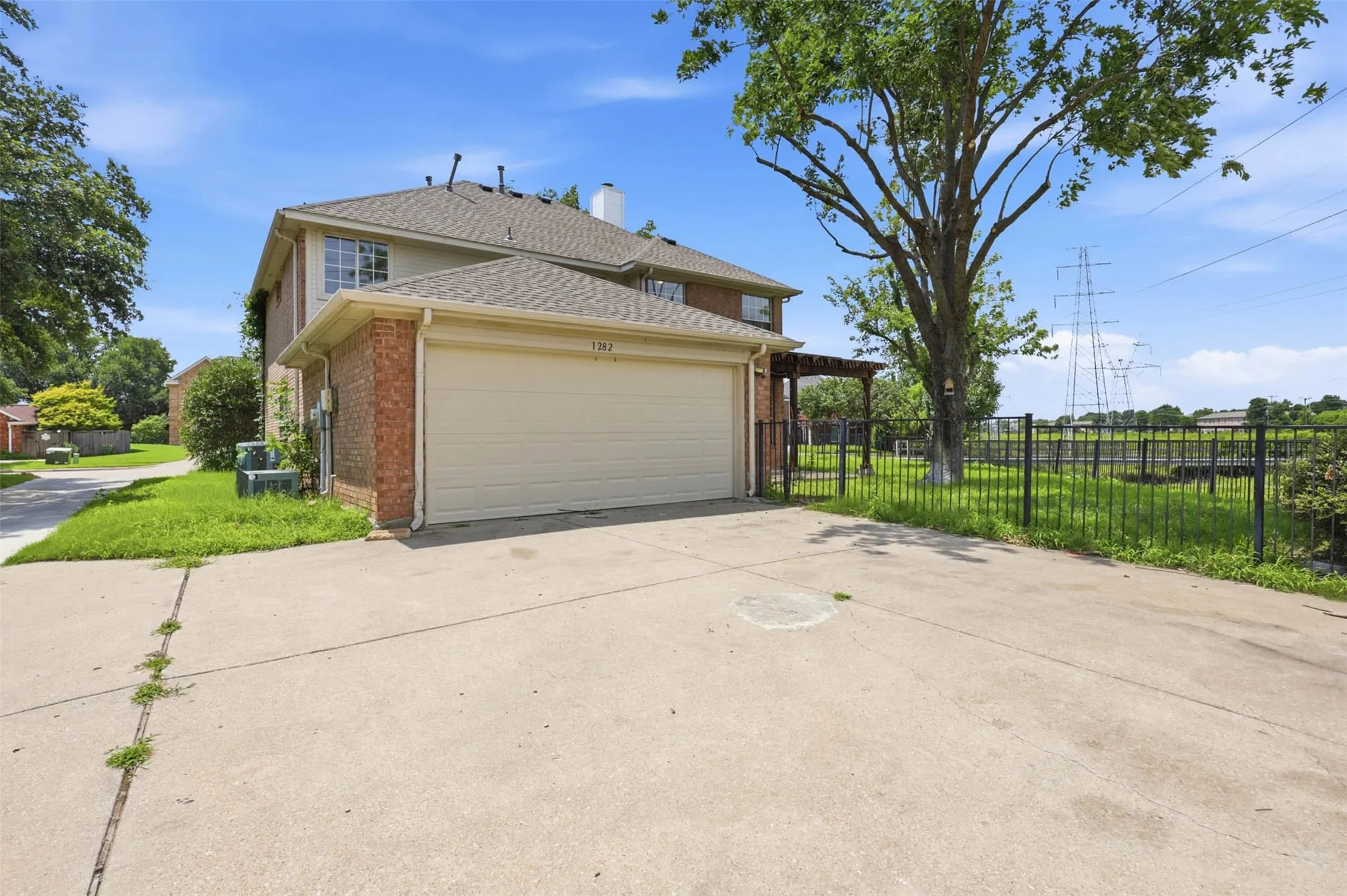 Concrete driveway leading to a two-car garage with an overhead door