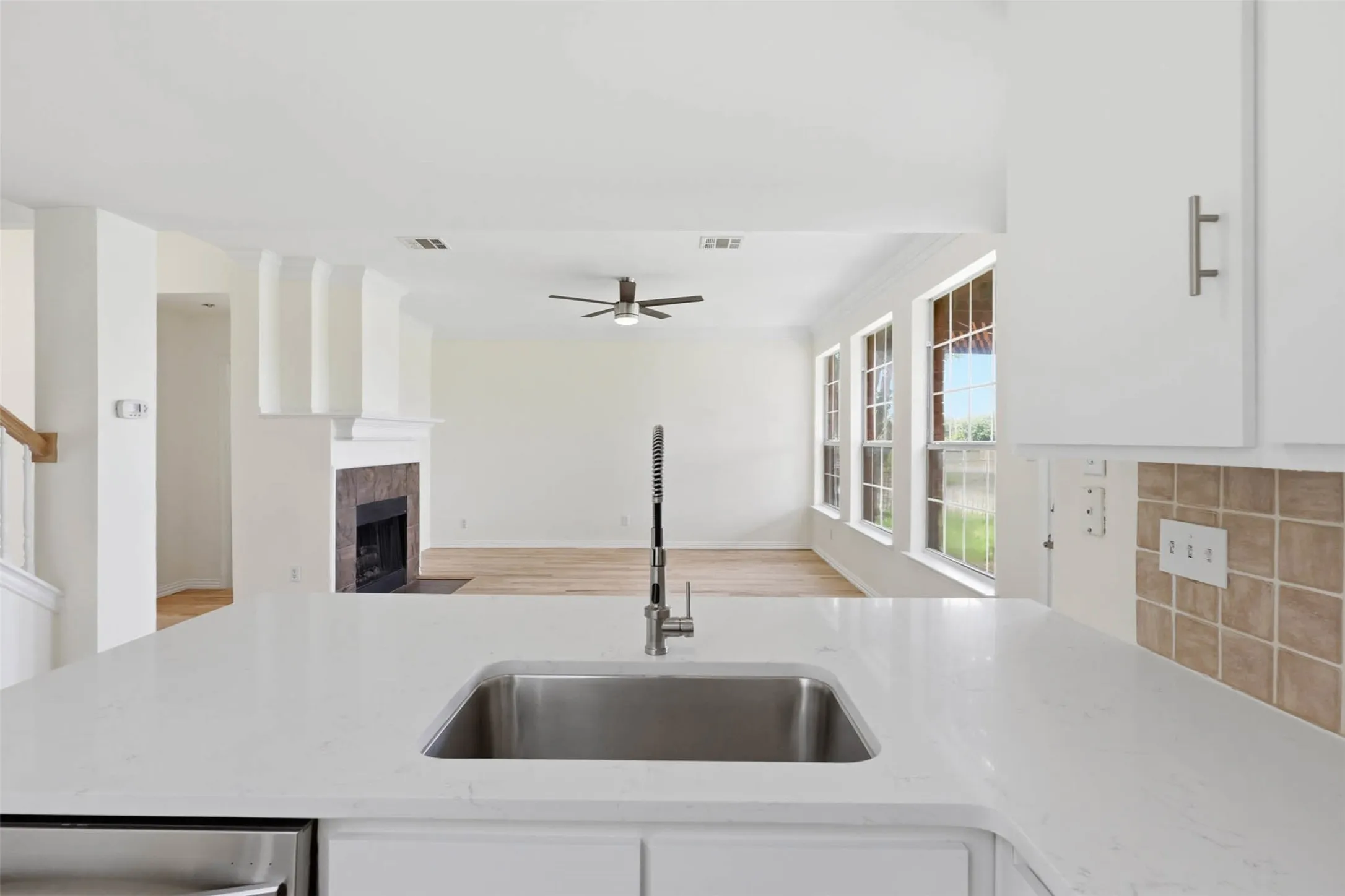 Kitchen island with a stainless steel sink and a contemporary pull-down faucet
