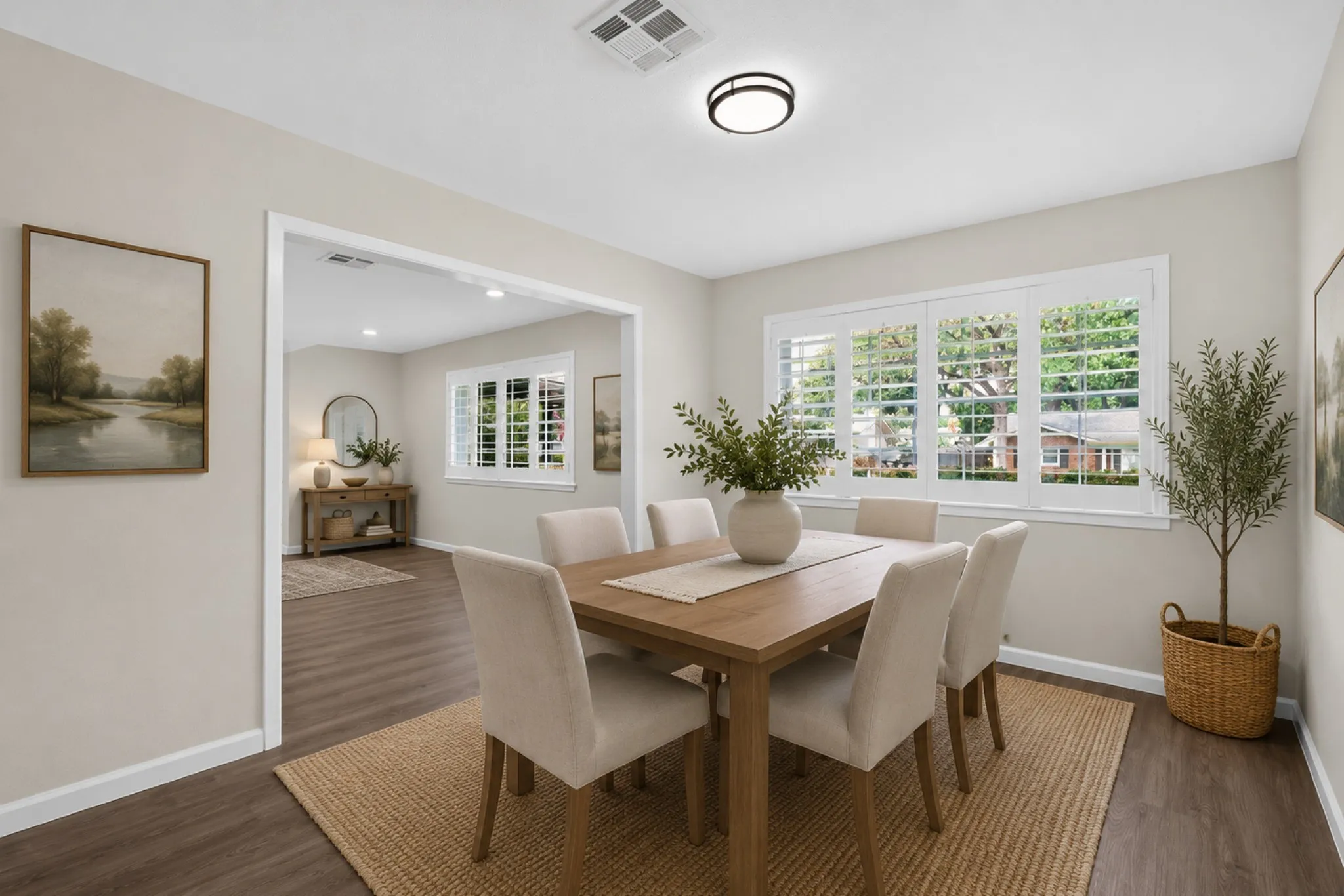 Dining area featuring wood-finish flooring, white baseboards, and a neutral wall color