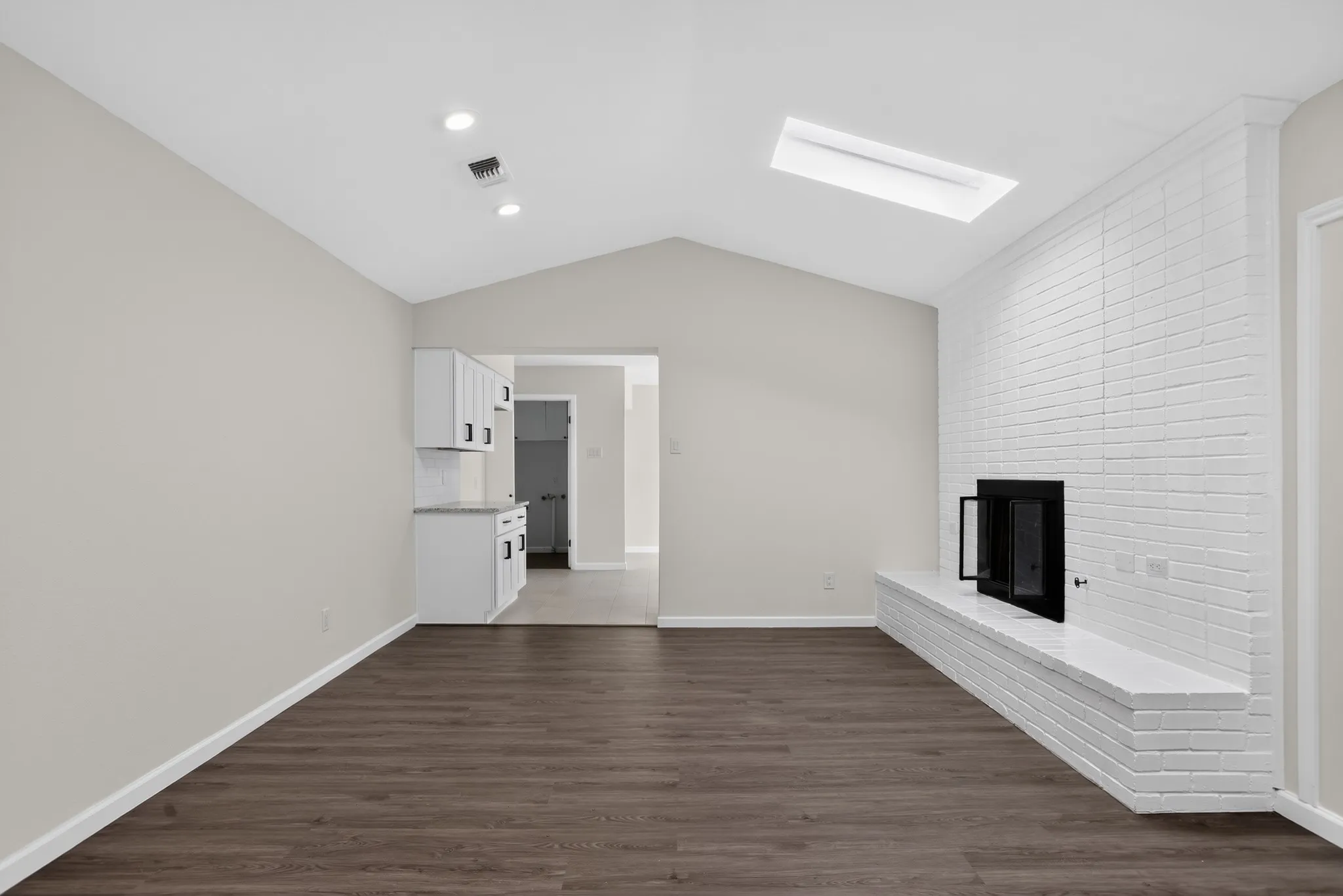 Vaulted ceiling featuring a skylight and recessed lighting