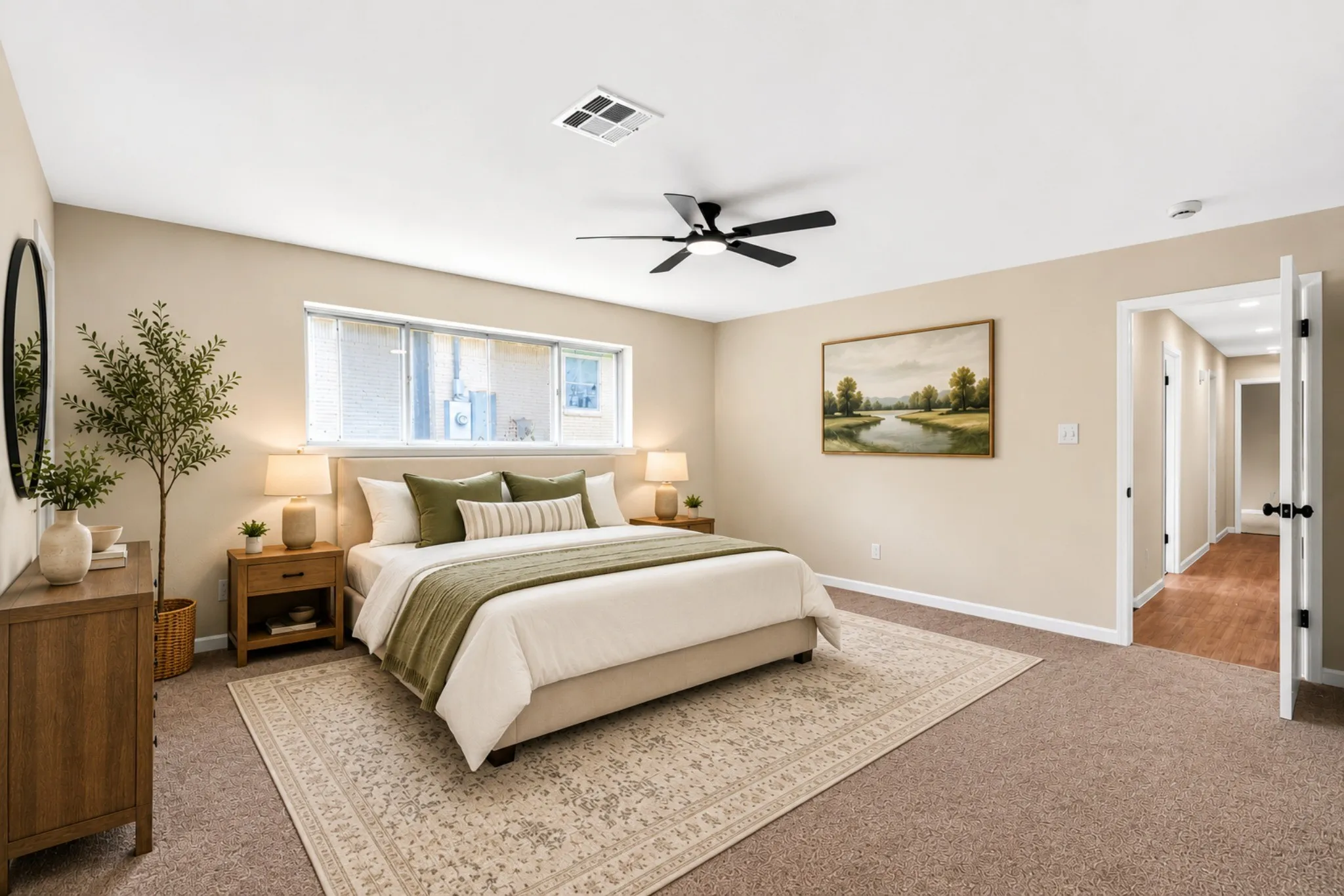 Spacious bedroom featuring neutral wall tones, large window with blinds, ceiling fan, and carpeted flooring