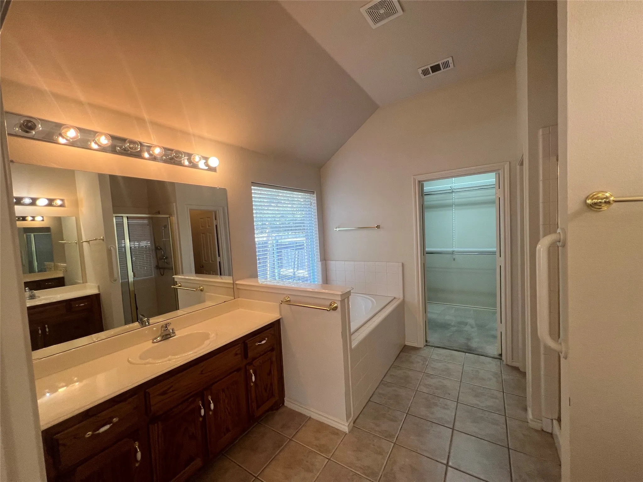 Dual vanity with wood-finish cabinetry and light-toned countertops