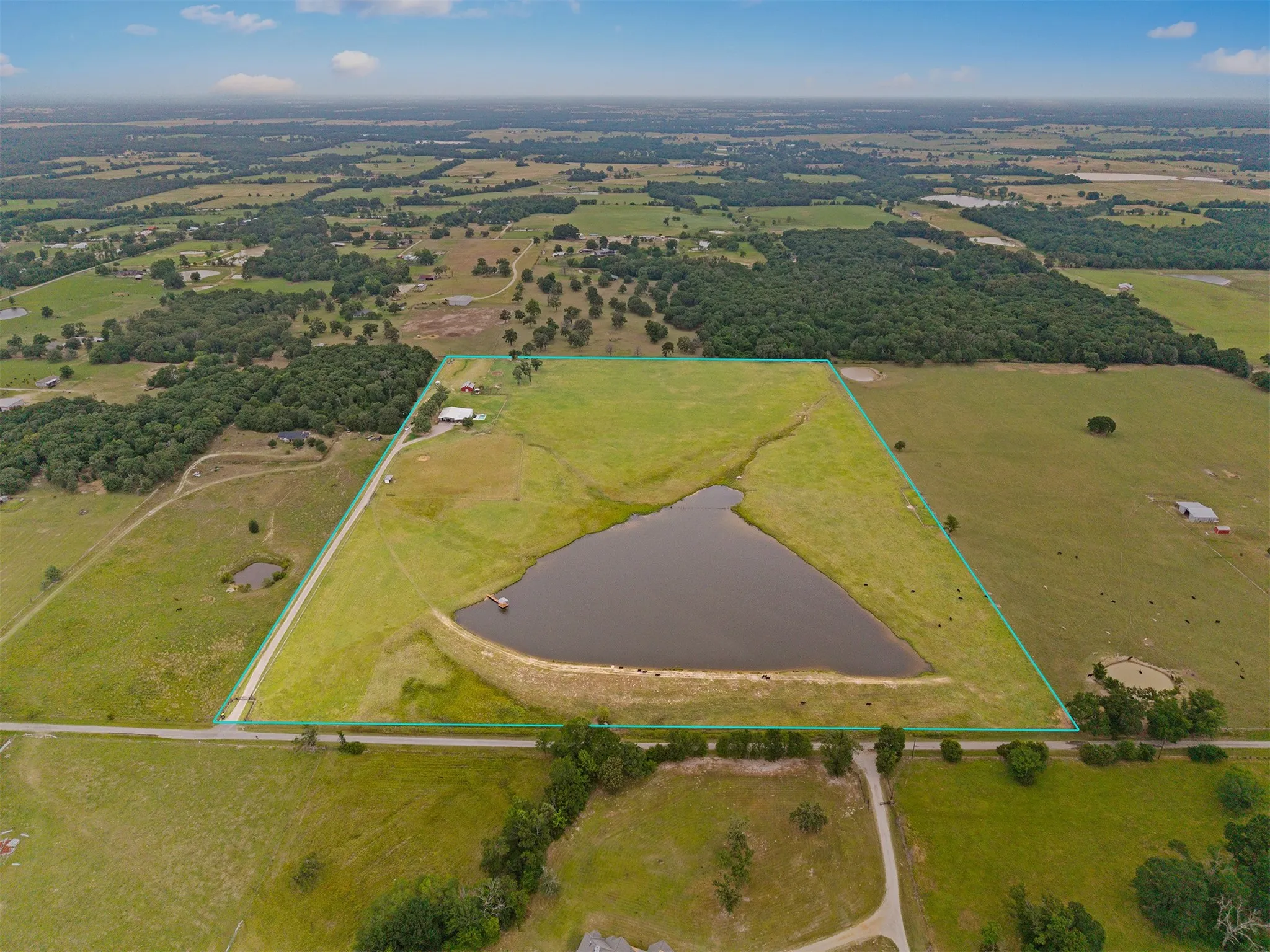 Expansive rural property featuring a large private pond and substantial acreage
