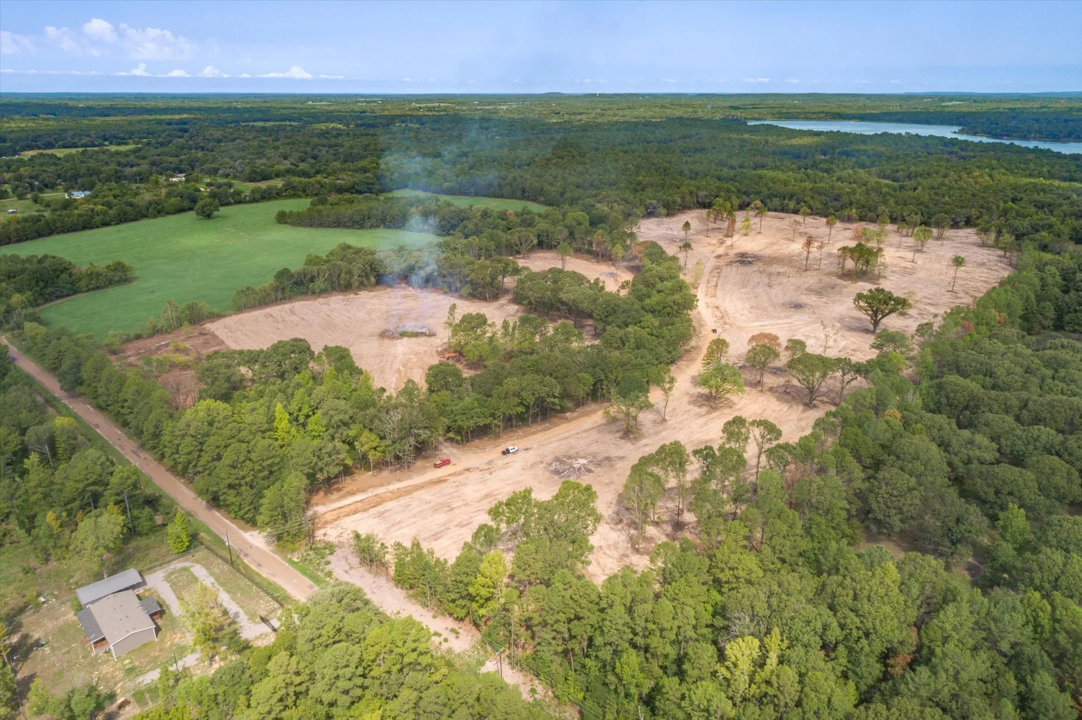 Aerial perspective highlighting cleared land surrounded by mature tree lines