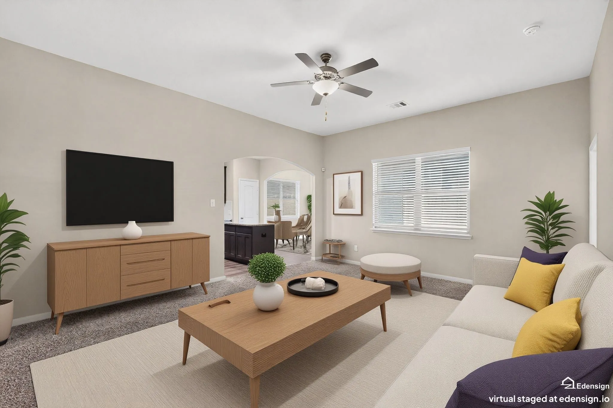 Living area featuring neutral wall tones and a ceiling fan with integrated lighting