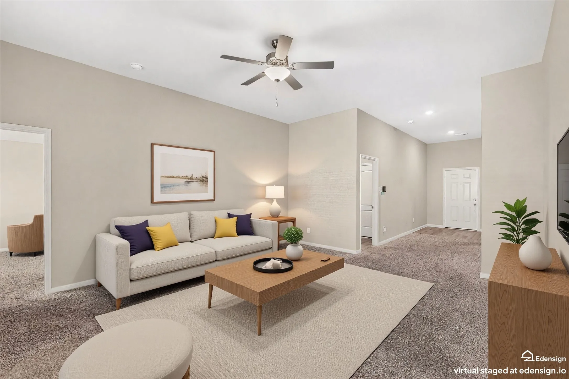 Spacious living area featuring neutral-toned walls, high ceilings, and plush carpet flooring throughout