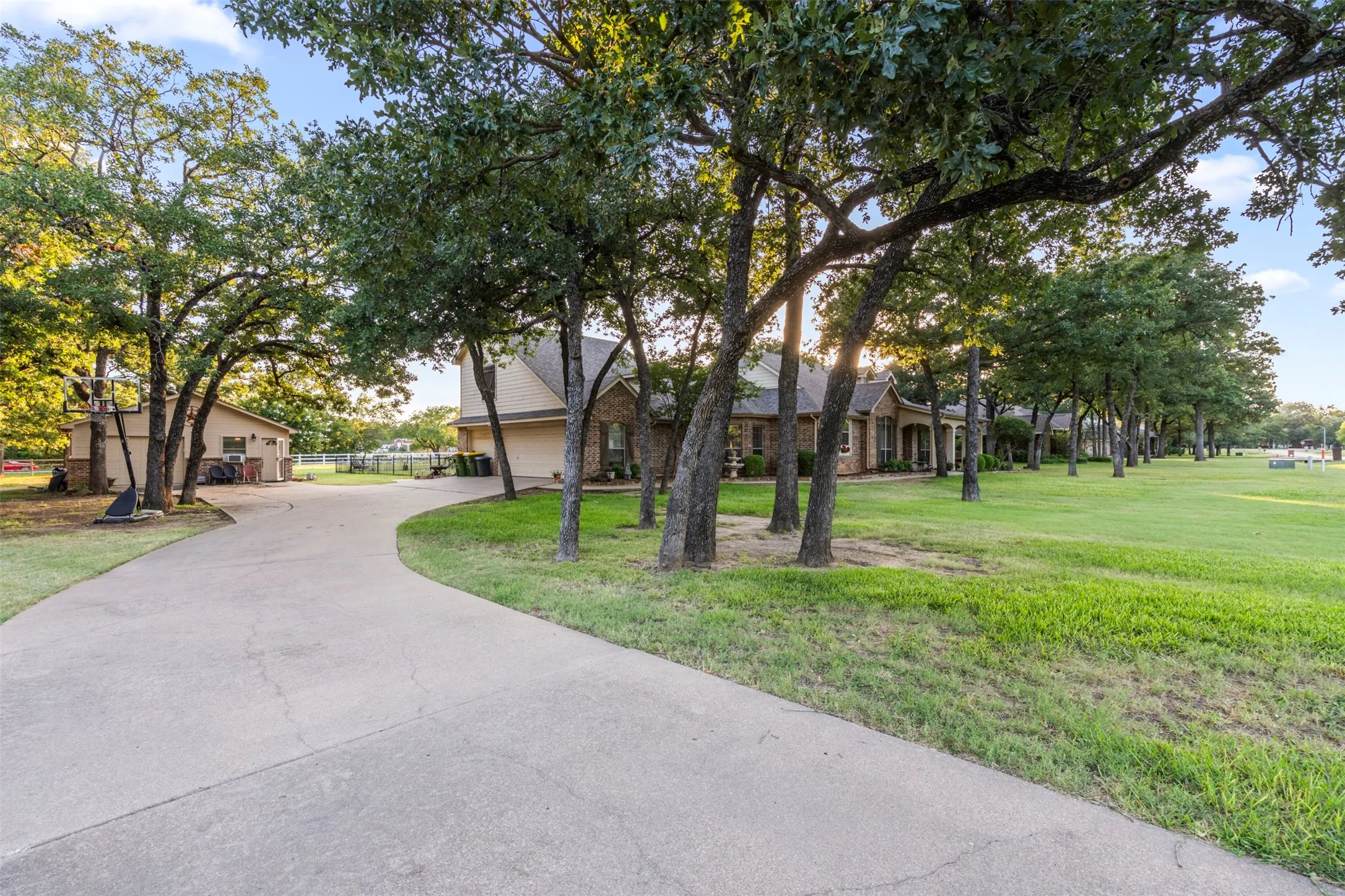 Drive through beutiful trees to your side entry 3-car garage.