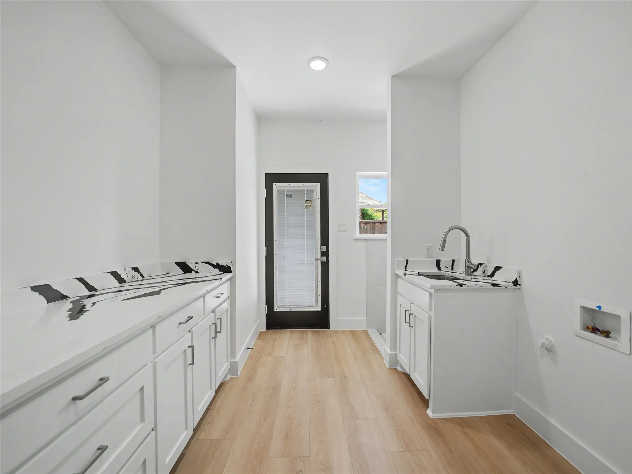 Utility space with light wood-finish flooring