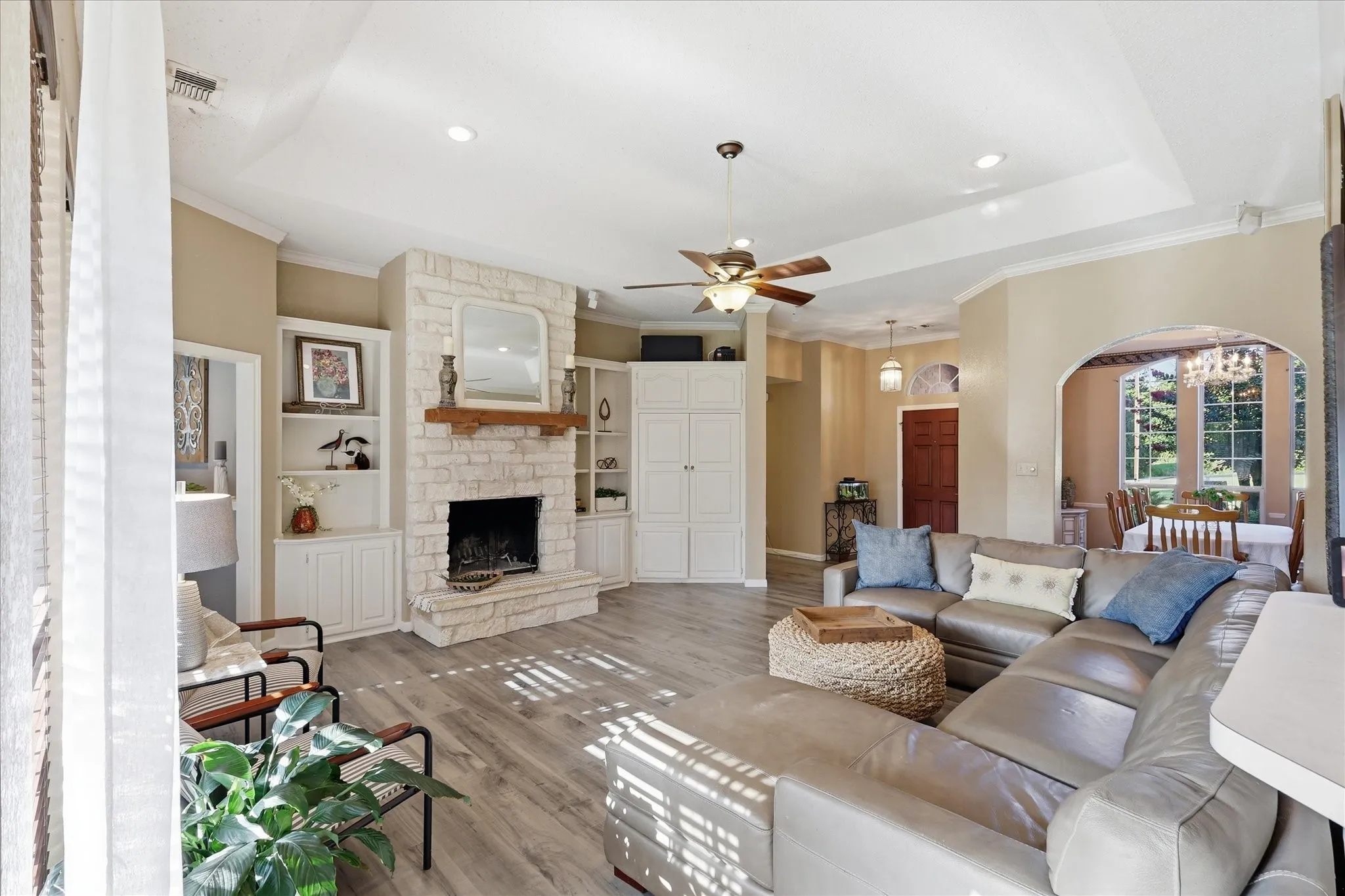 Stone-clad fireplace with wood mantel and hearth