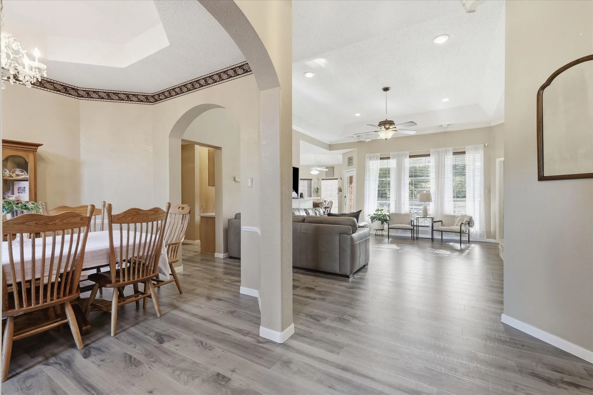 Spacious interior featuring wood-finish flooring, recessed lighting, and a tray ceiling