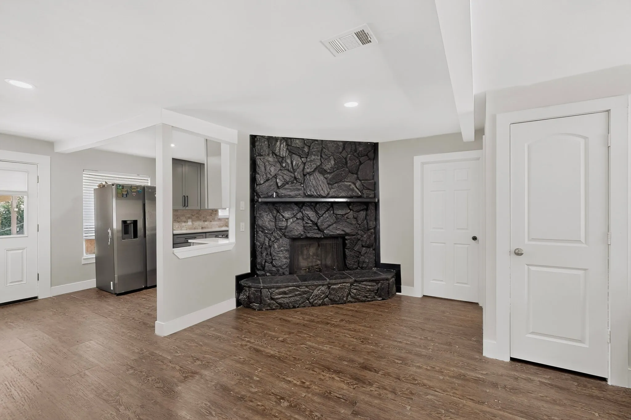 Corner fireplace with dark stone surround and hearth