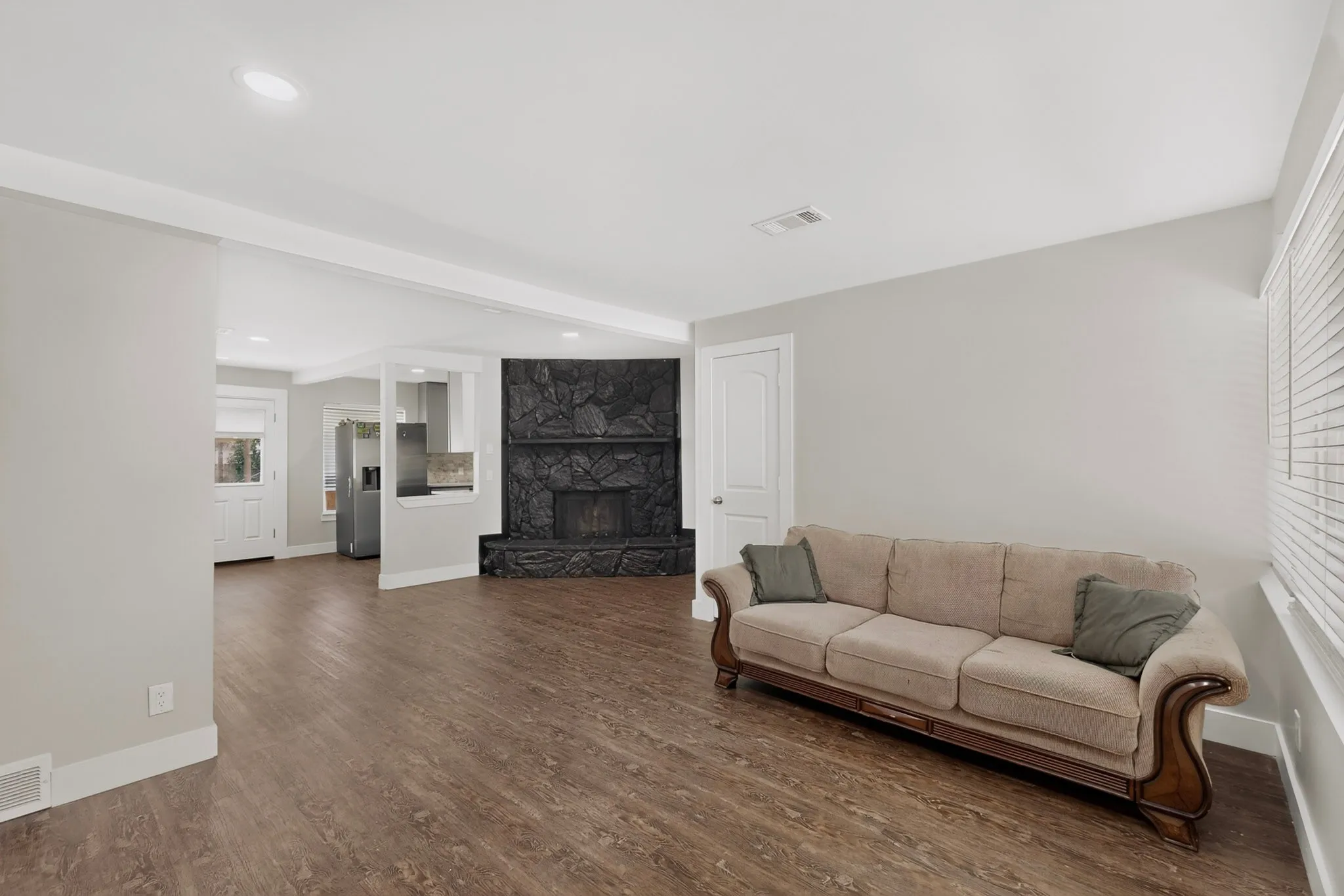 Living area featuring wood-finish flooring and recessed lighting