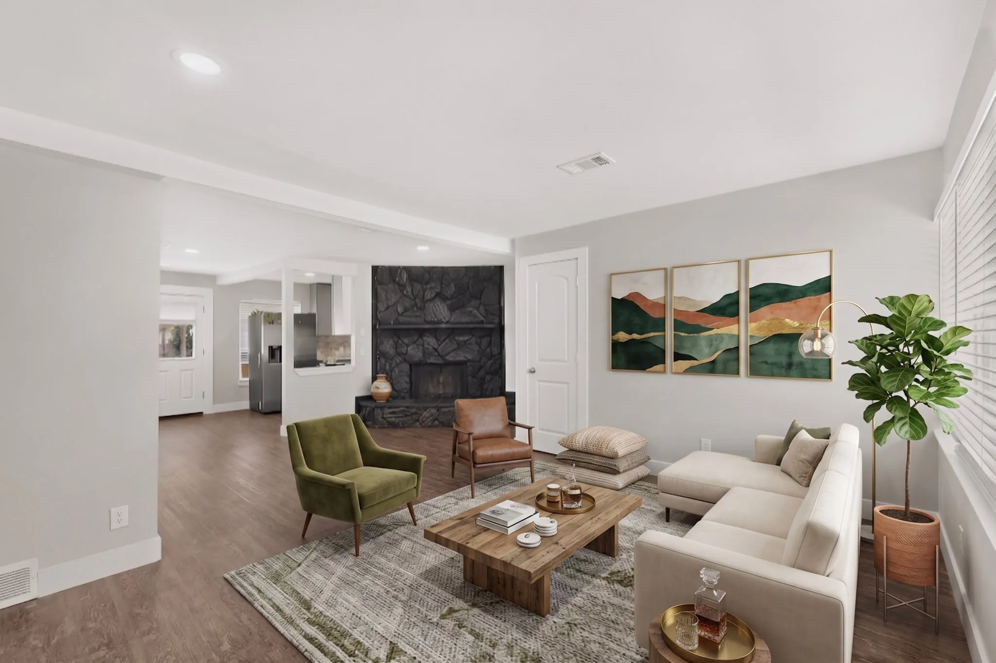 Spacious living area featuring wood-finish flooring, recessed lighting, a stone fireplace, and white trim