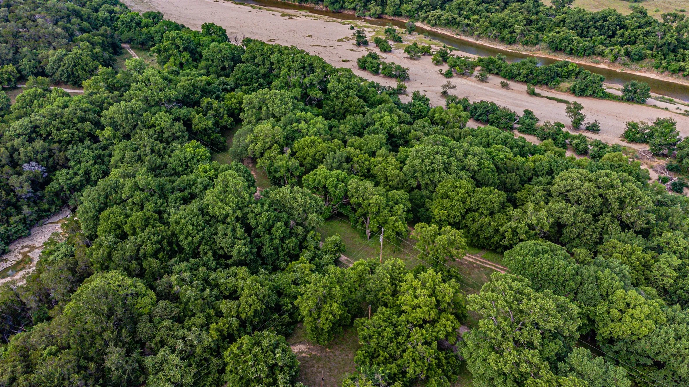 Expansive wooded property featuring mature trees and a riverfront boundary