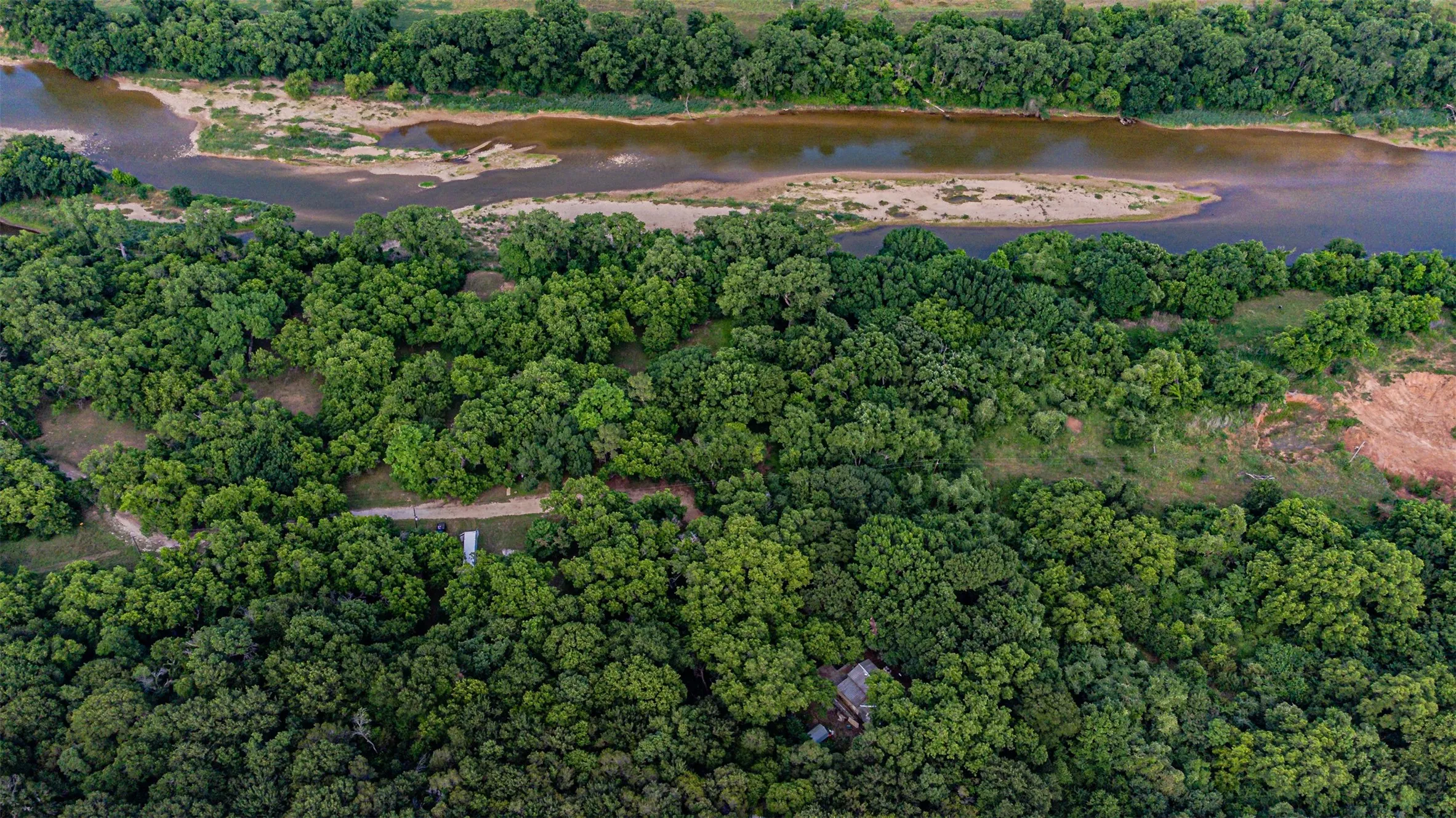 Expansive treed landscape with a winding river and sandbars