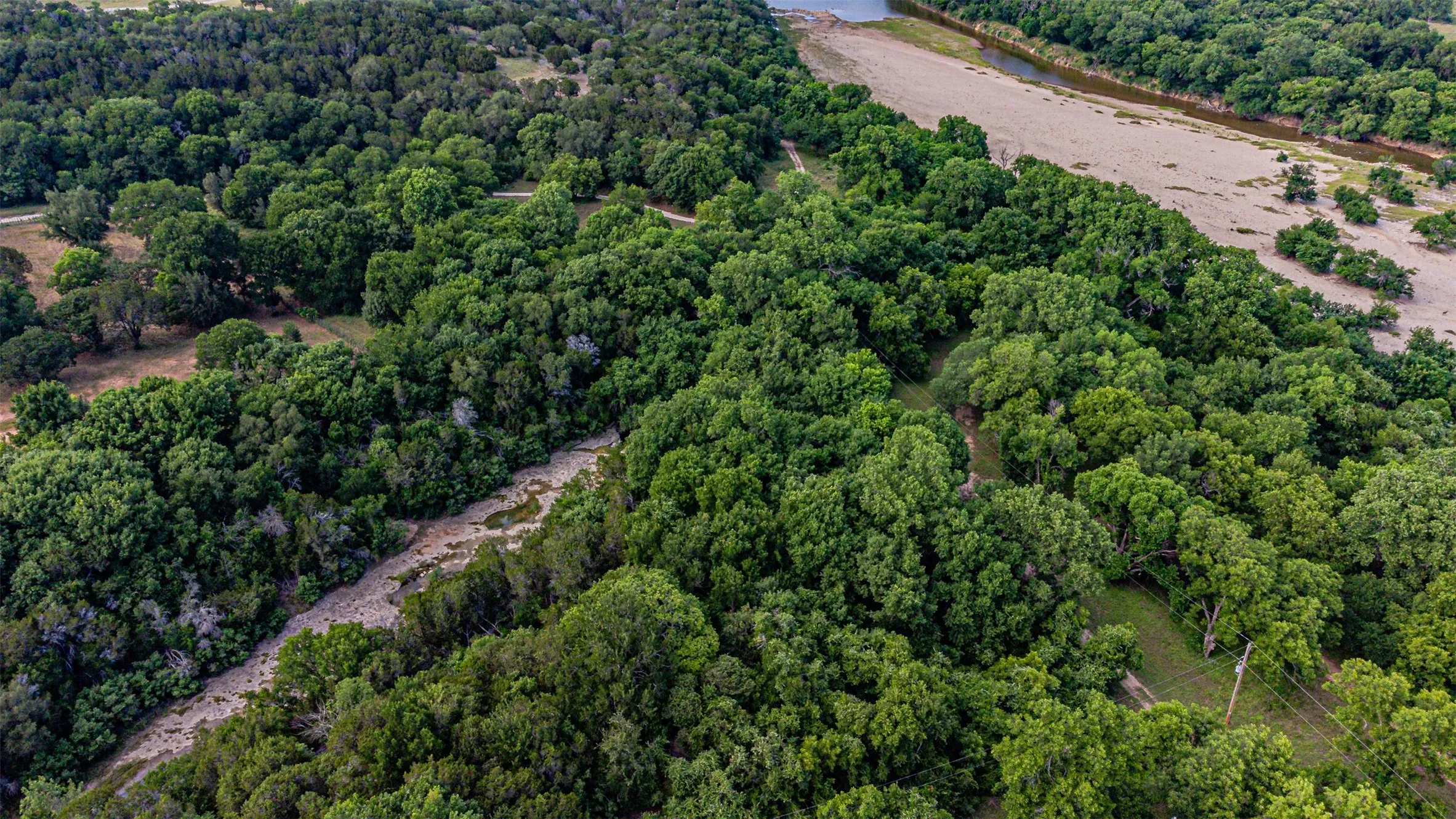 Expansive wooded property featuring mature trees and a riverfront
