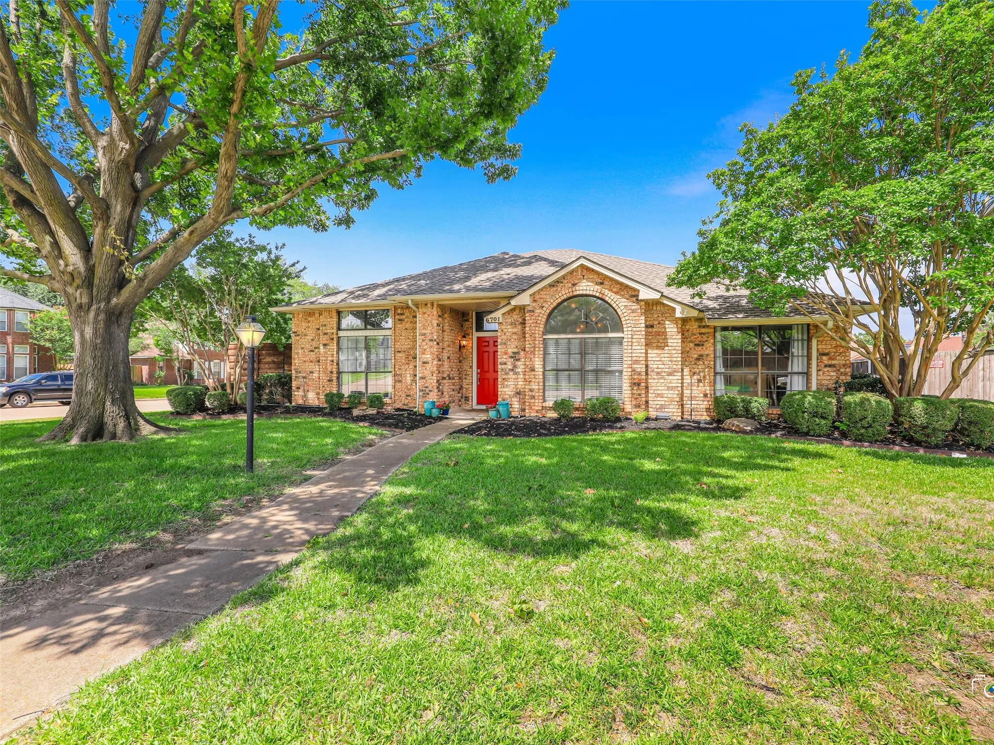 This large corner lot features mature trees and landscaping.