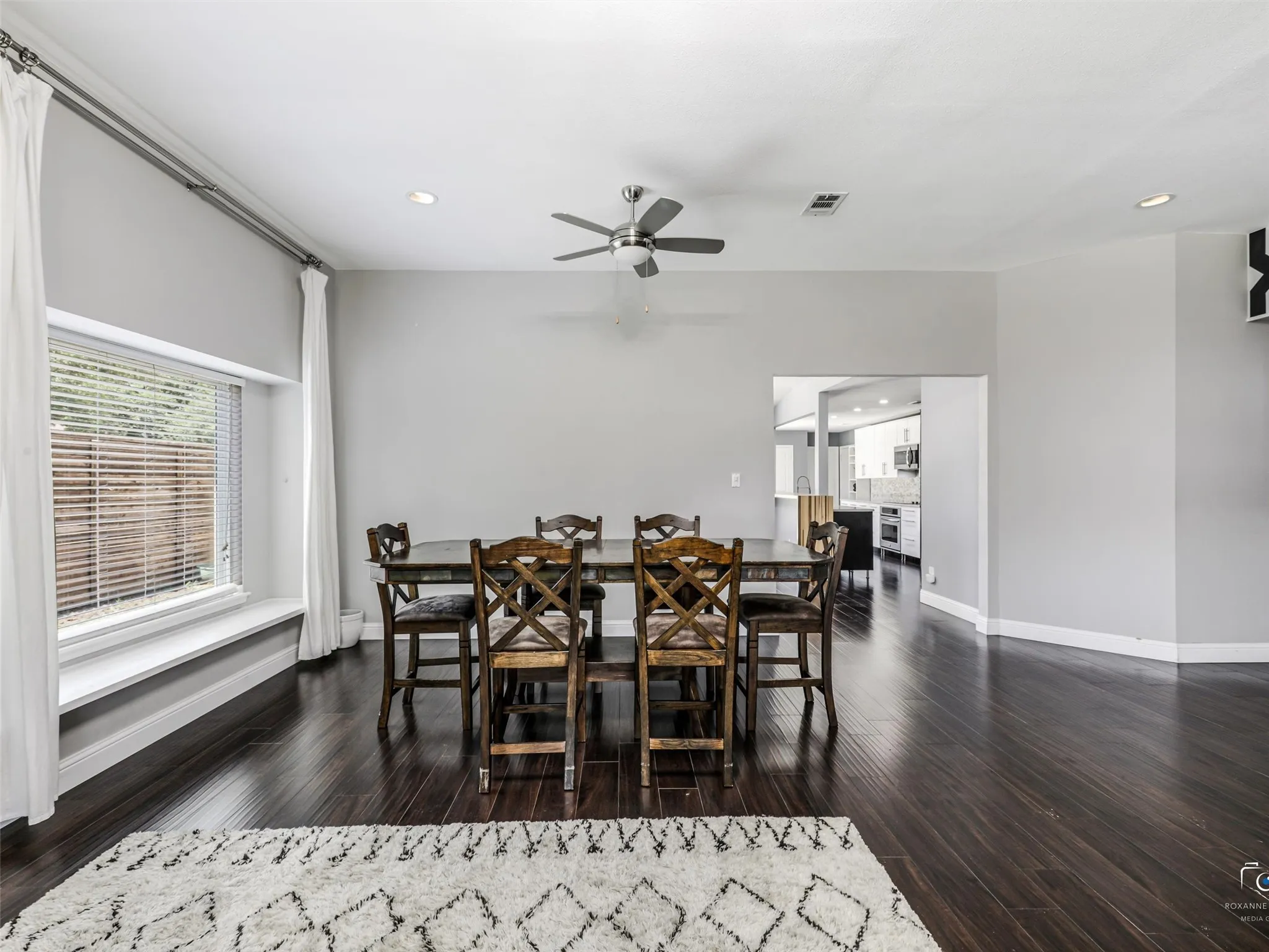 The dining room features a window seat window and opens to the kitchen.
