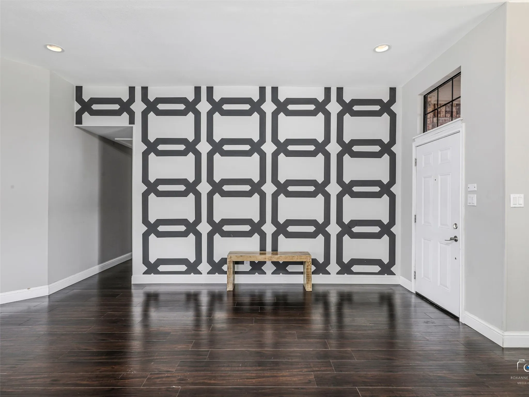 As you enter the home through the front door, note the feature wall and beautiful wood floors.