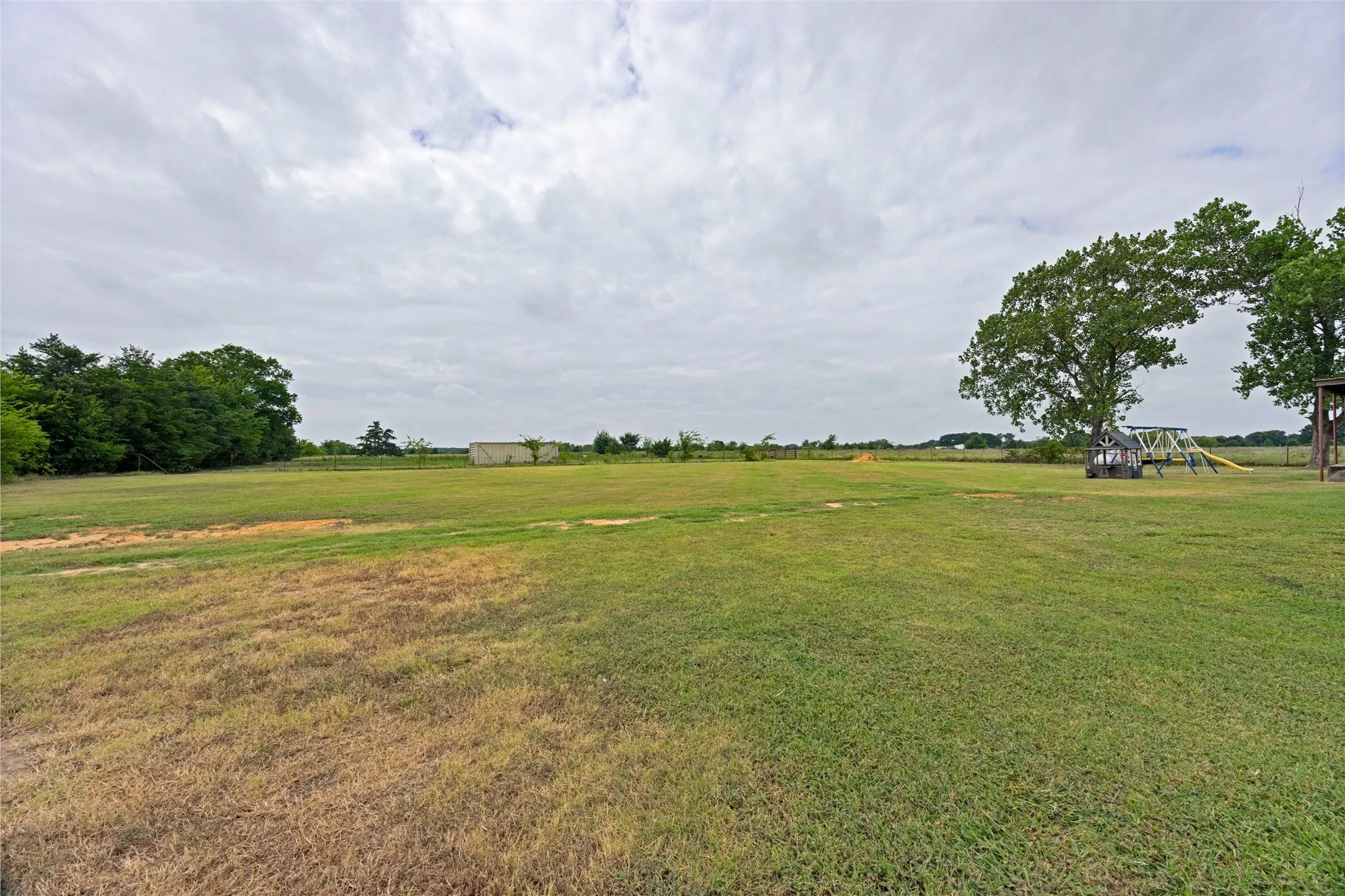 Backyard looking out the fenced pasture