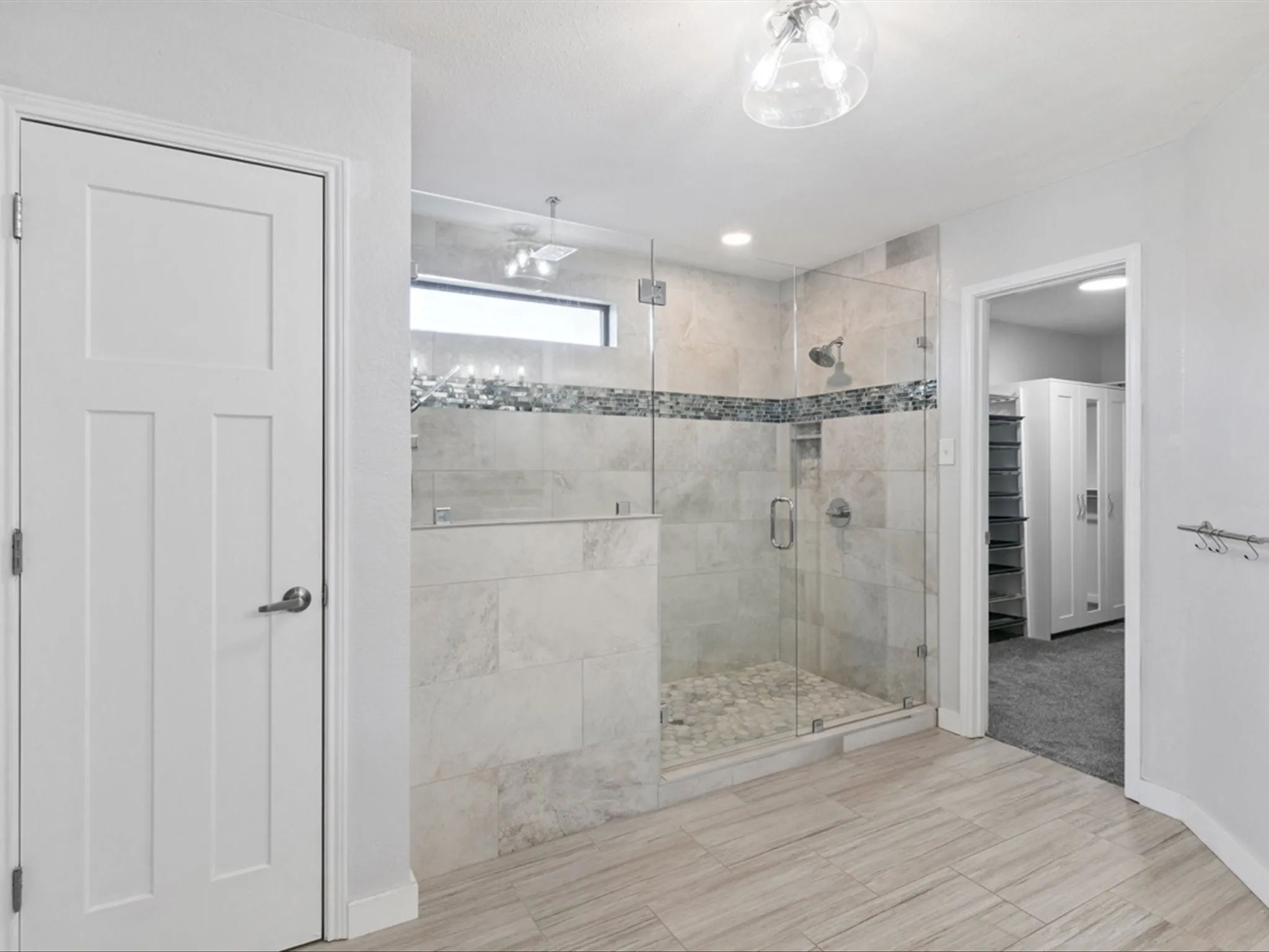Bathroom featuring a stall shower and a walk in closet