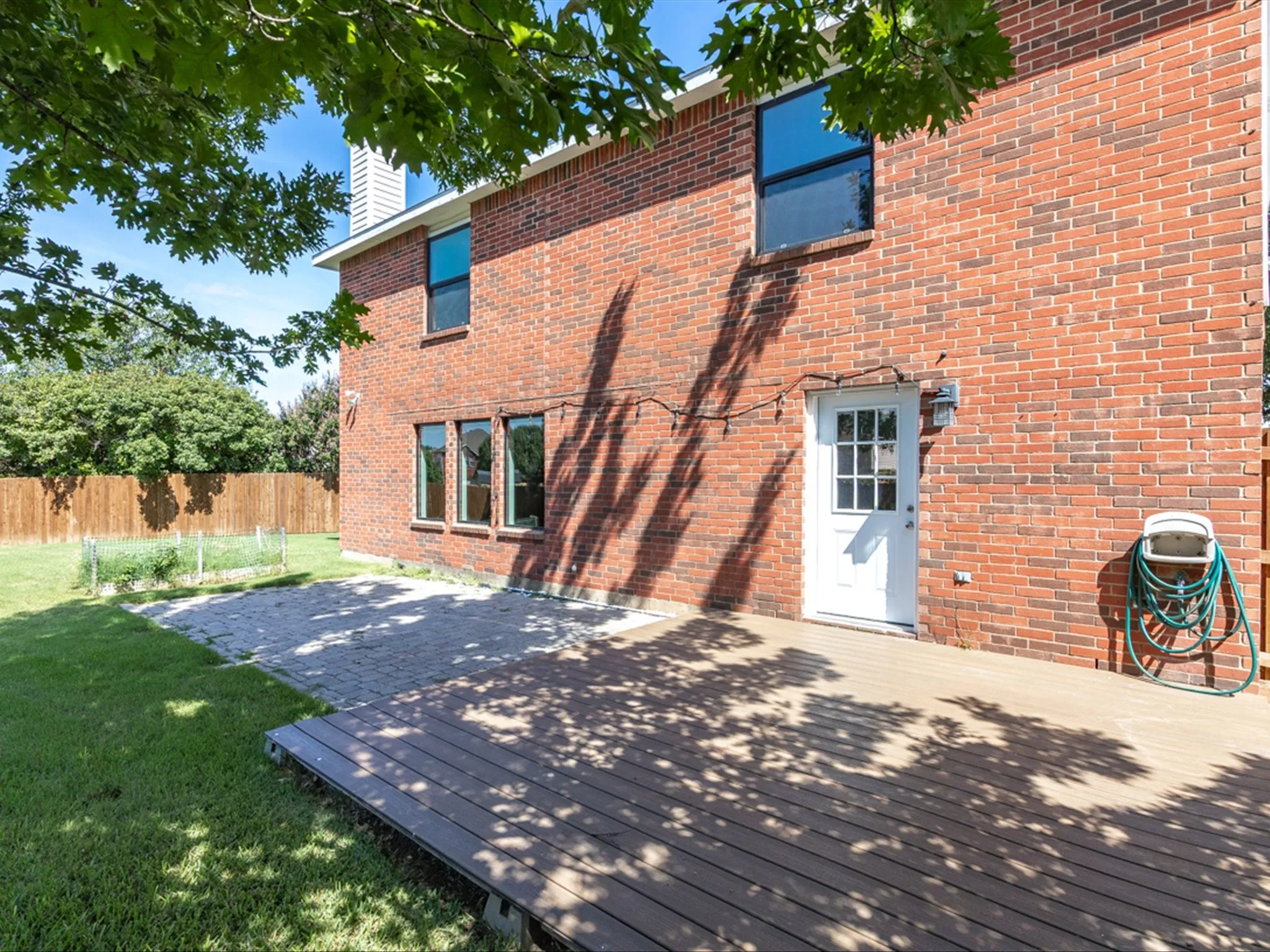 Rear view of house with brick siding and a chimney