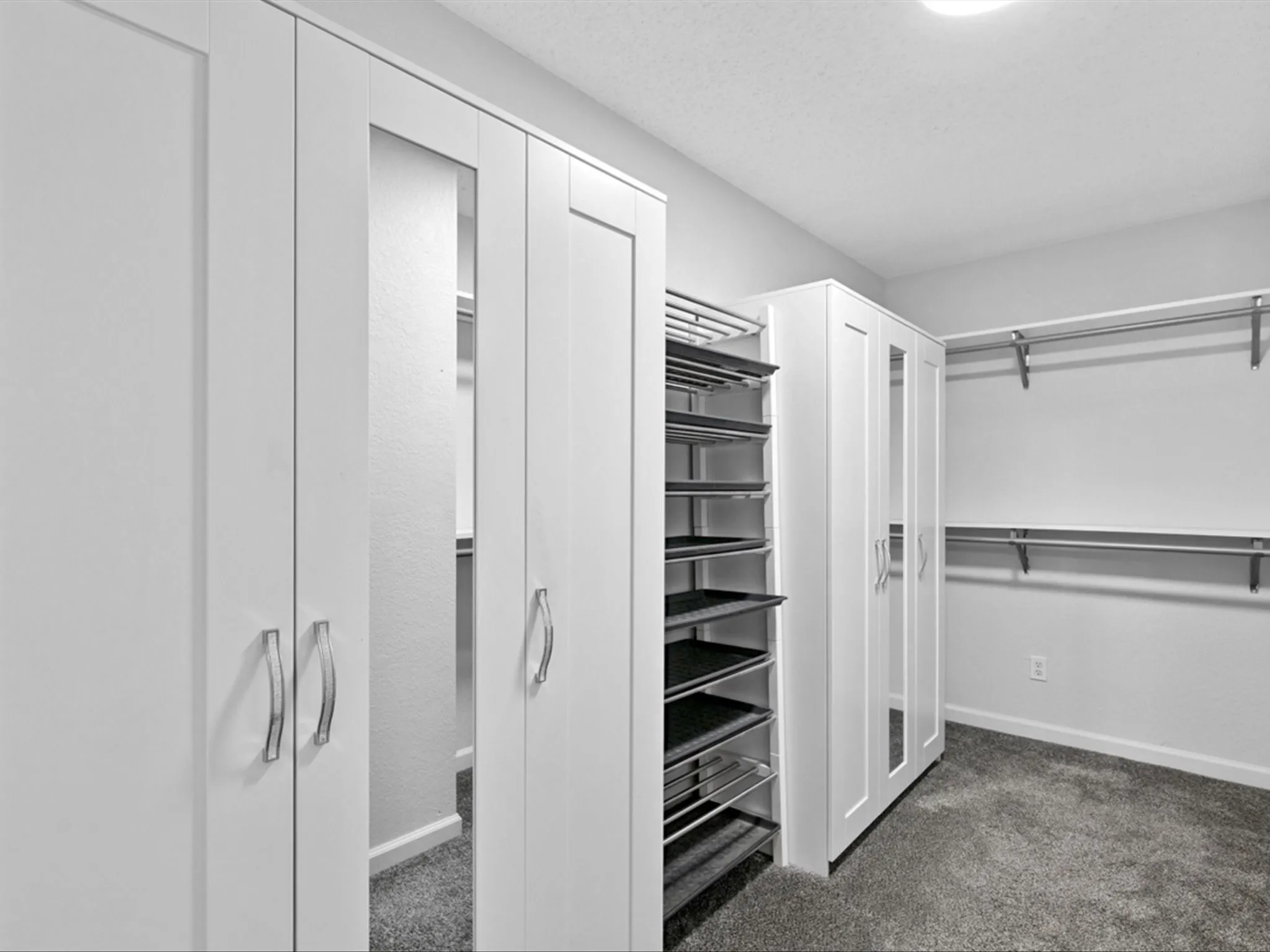 Walk in closet featuring dark colored carpet