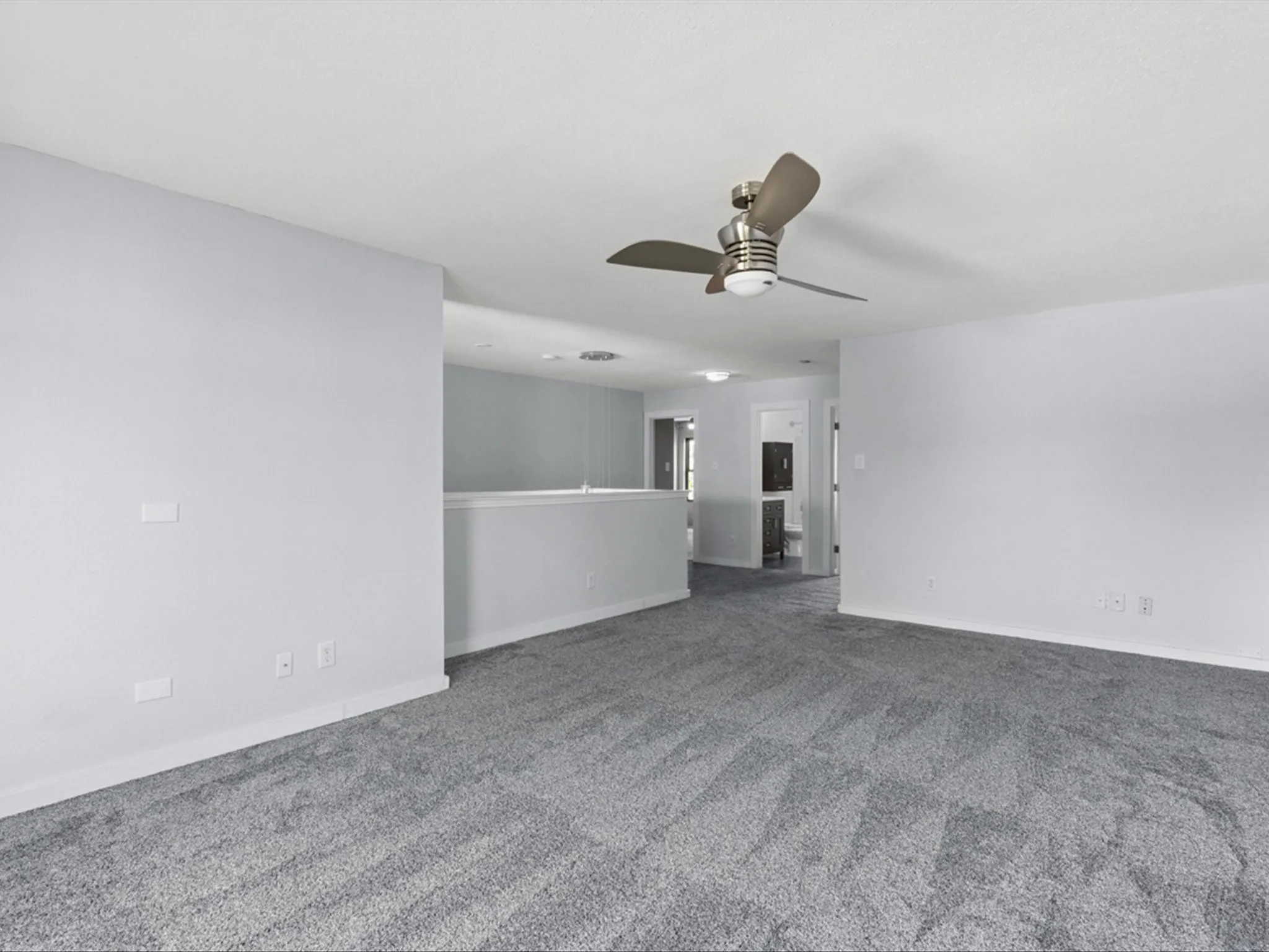 Empty room with ceiling fan and carpet flooring
