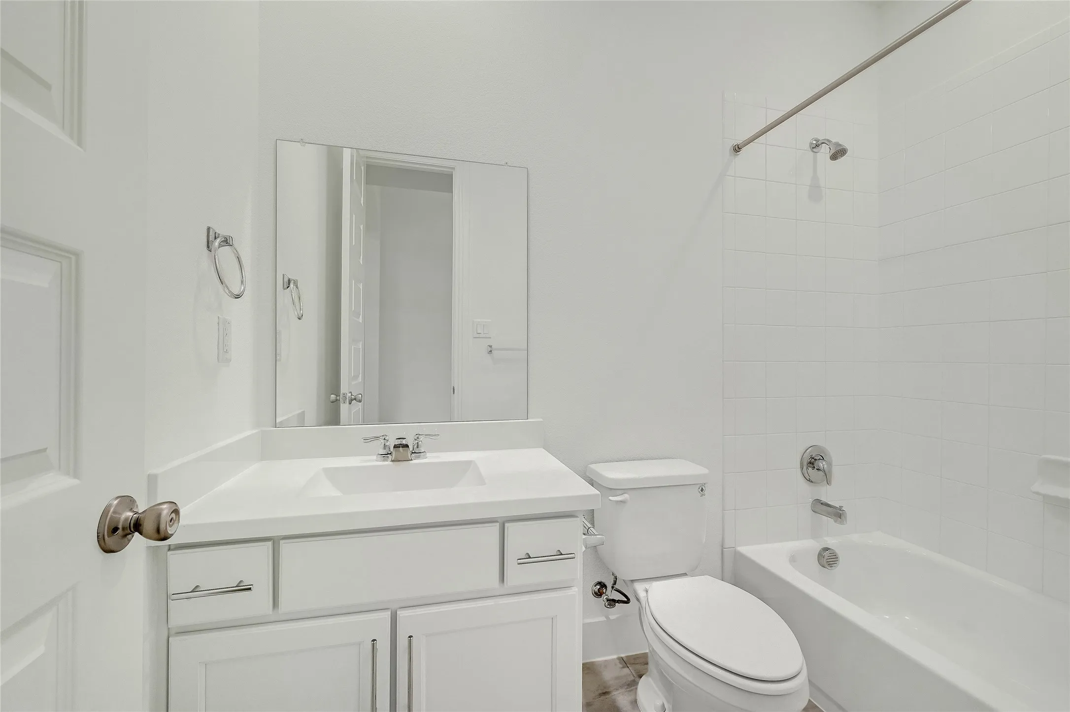 Bathroom with toilet,  shower combination, baseboards, and vanity