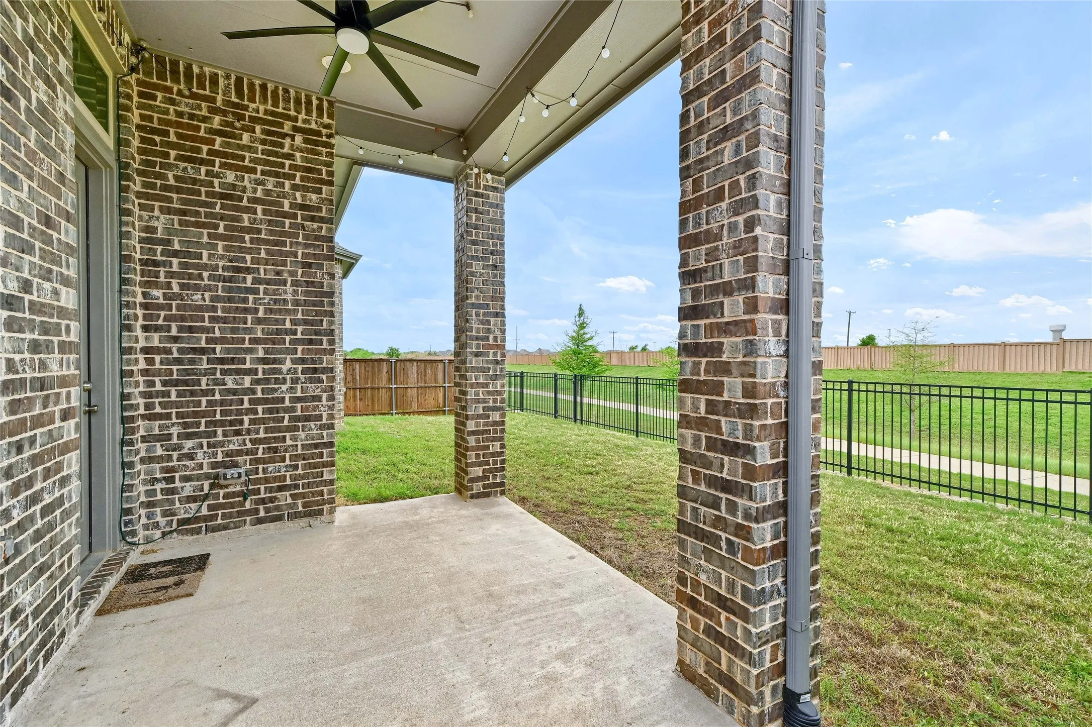 View of patio featuring a fenced backyard and ceiling fan