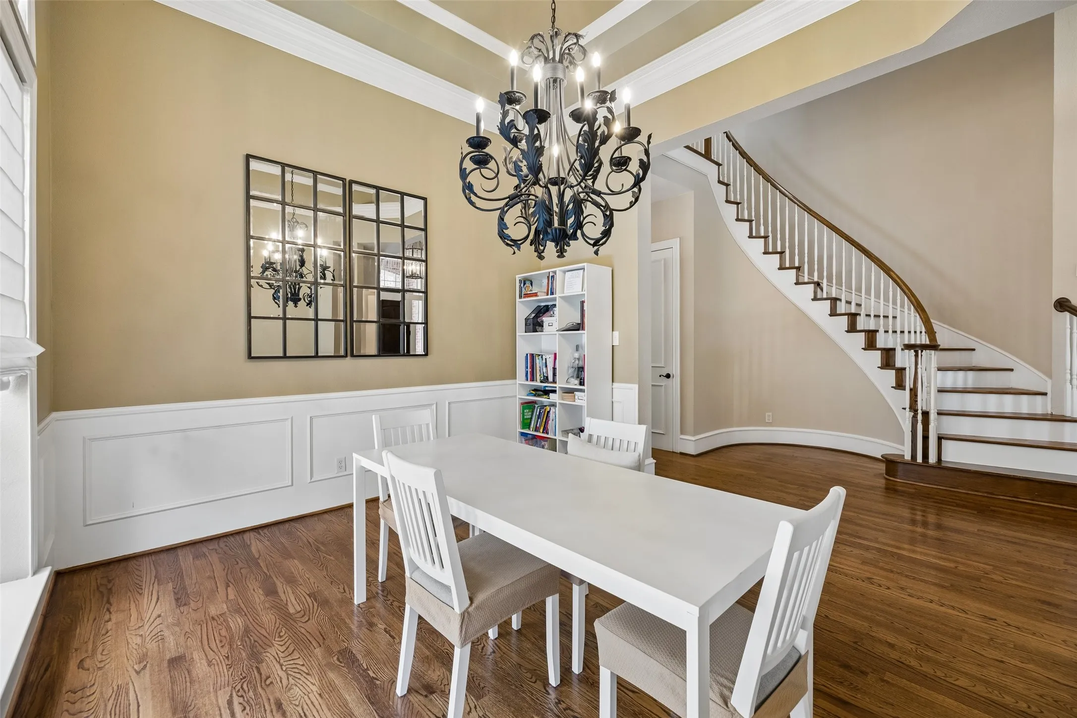 Formal dining area featuring hardwood flooring, wainscoting, and a coffered ceiling
