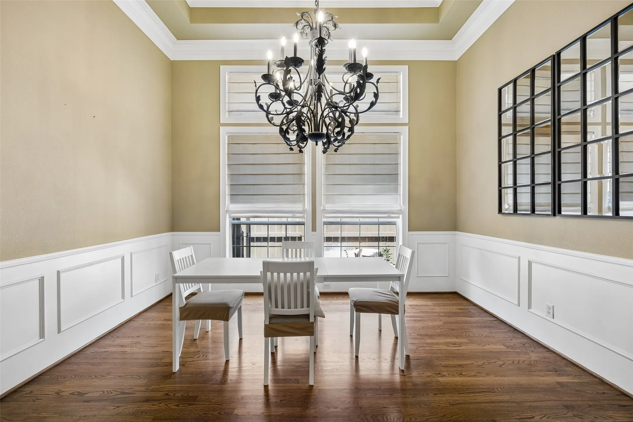Hardwood flooring throughout featuring extensive wainscoting and crown molding