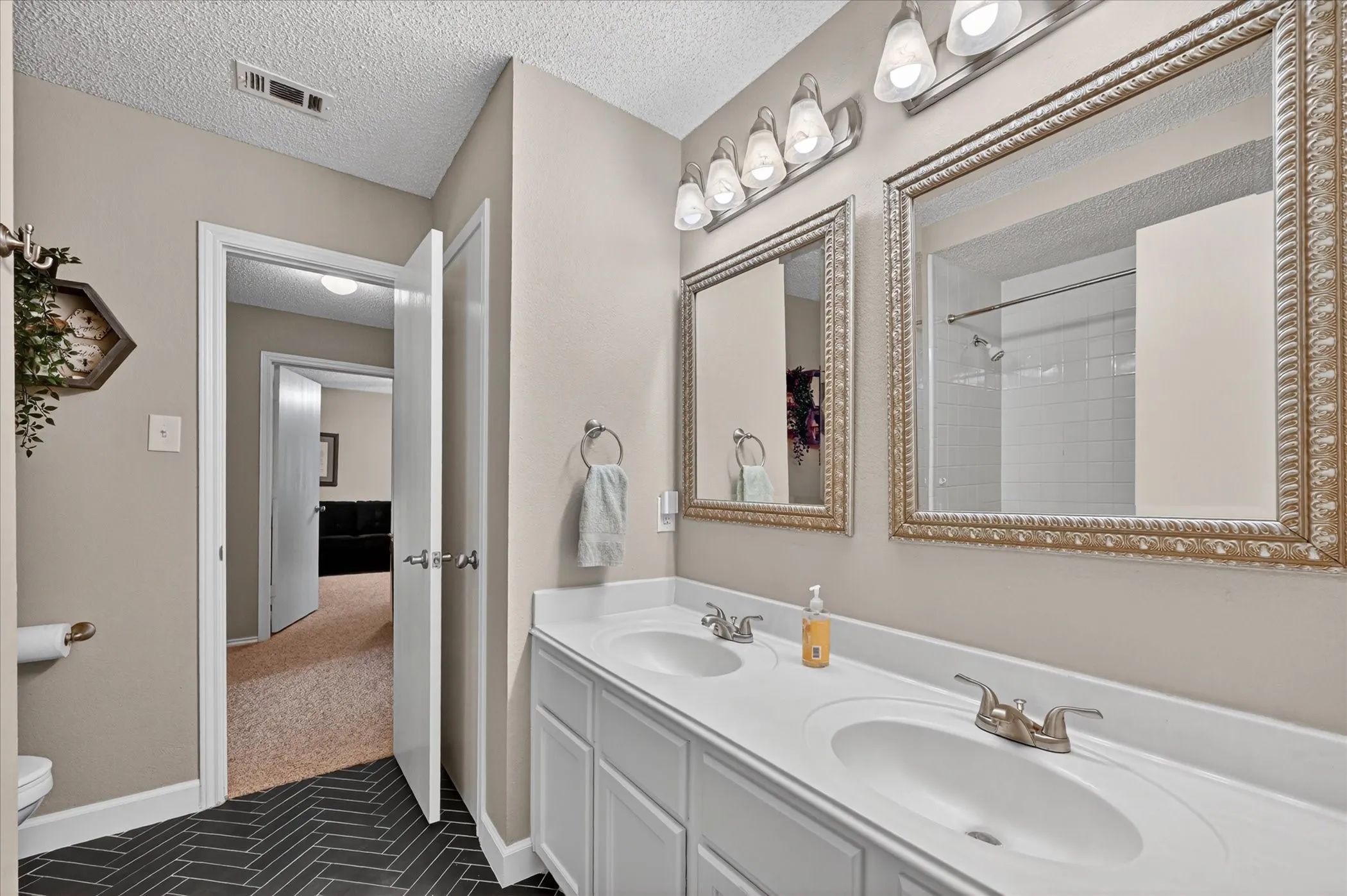 Upstairs hall bathroom with double sinks