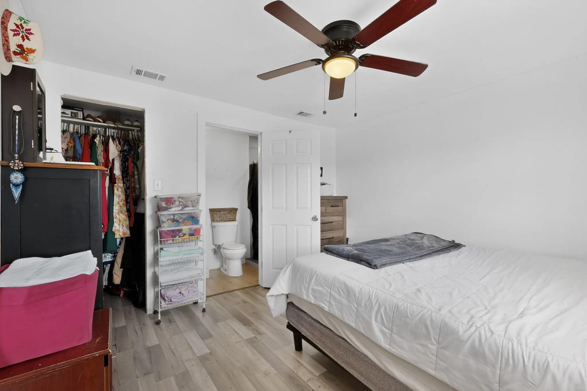 Room featuring light wood-finish flooring and a ceiling fan with integrated lighting