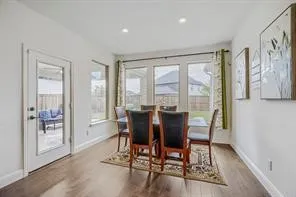 Dining area featuring wood-finish flooring and recessed lighting