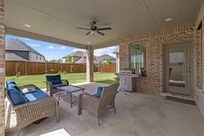 Covered patio featuring a ceiling fan with integrated lighting, recessed lighting, and brick exterior​​‌​​​​‌​​‌‌​‌‌​​​‌‌​‌​‌​‌​​​‌​​ walls