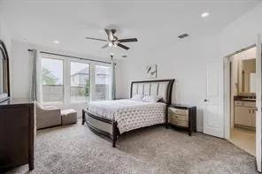 Spacious bedroom featuring carpet flooring, recessed lighting, and a ceiling fan