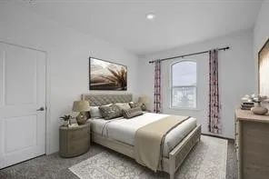 Bedroom featuring a paneled interior door, a recessed ceiling light, and a window with an arched transom